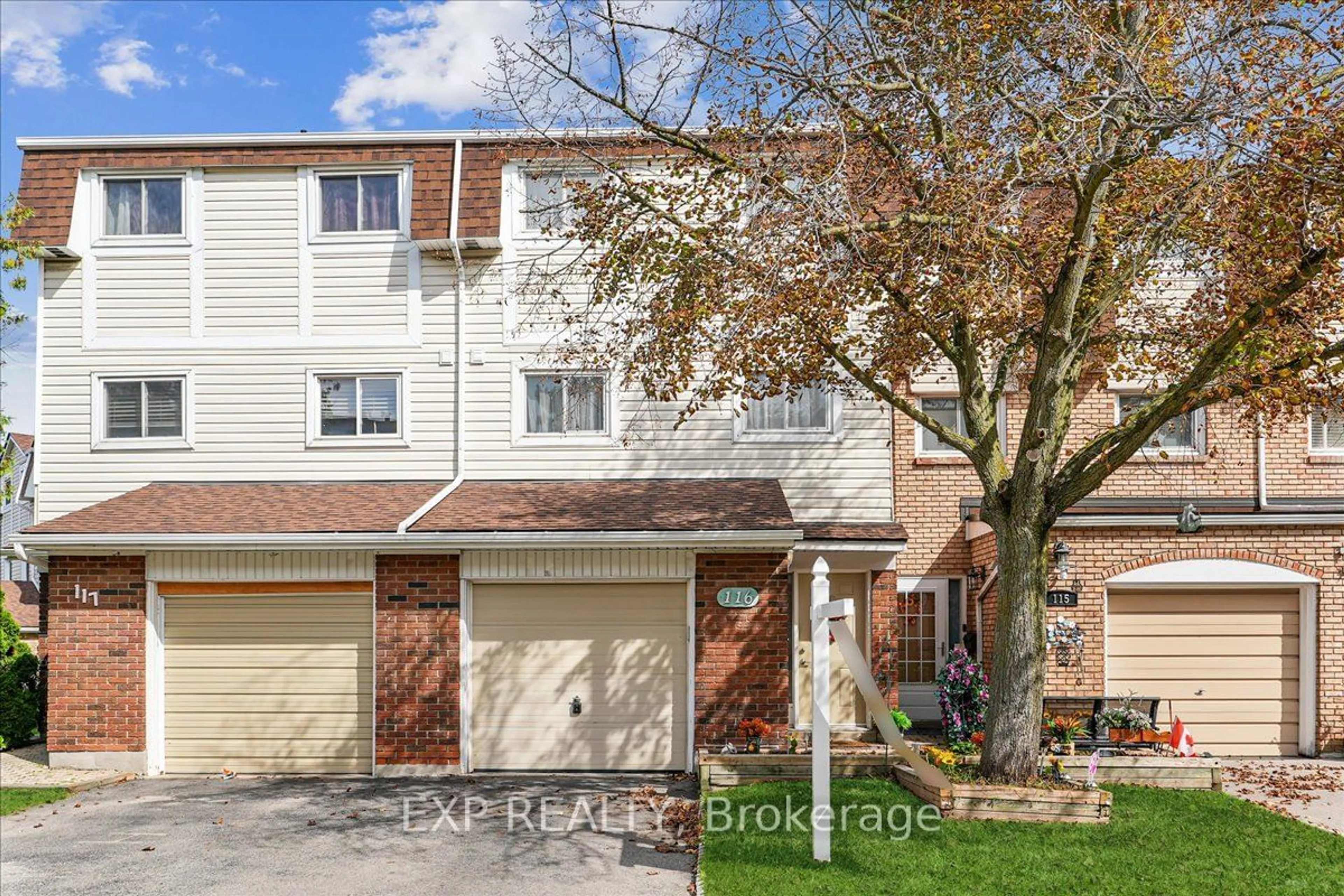 A pic from exterior of the house or condo, the fenced backyard for 11 Harrisford St #116, Hamilton Ontario L8K 6L7