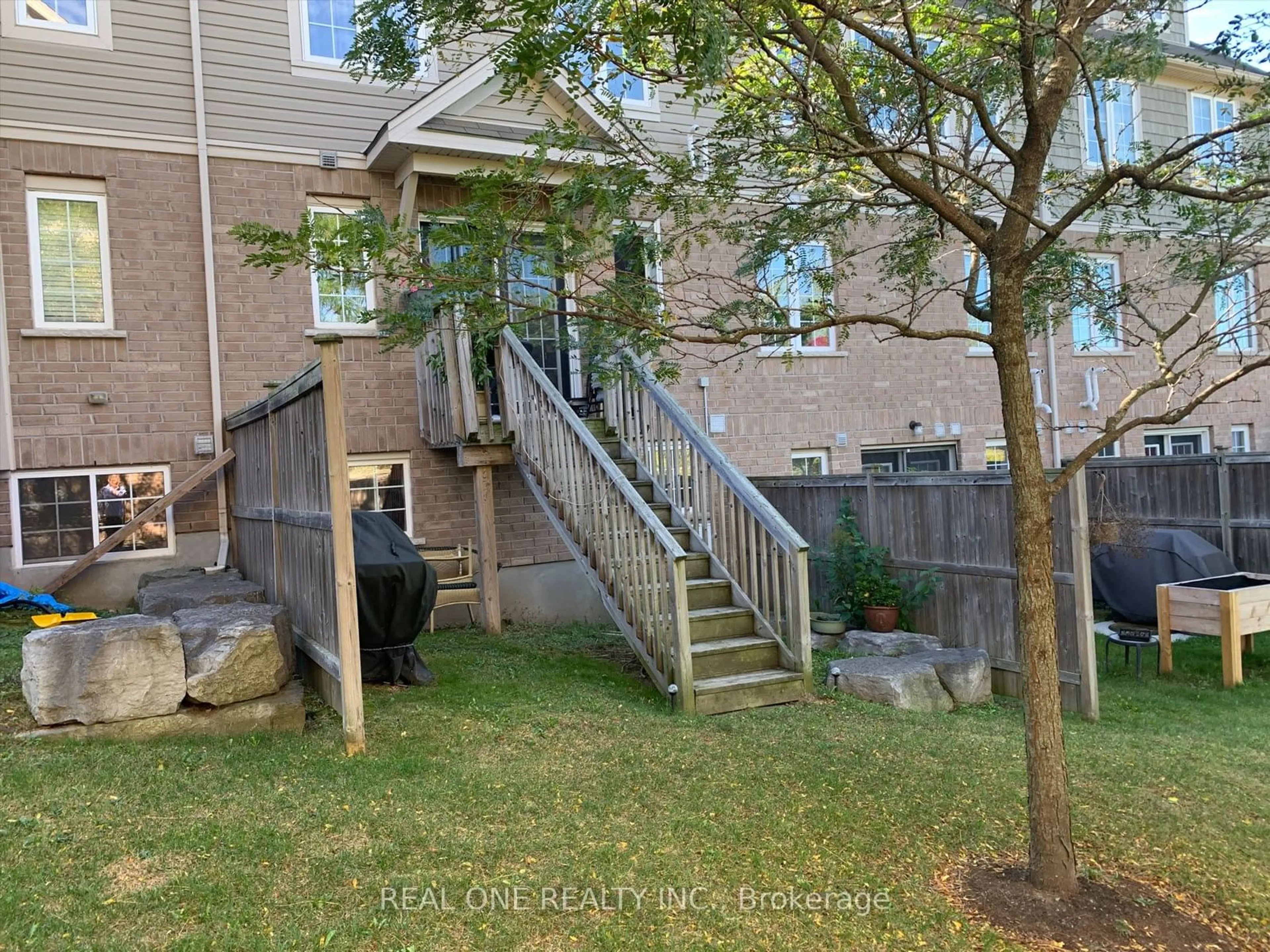 A pic from exterior of the house or condo, the fenced backyard for 15 Carere Cres #40A, Guelph Ontario N1E 0K4