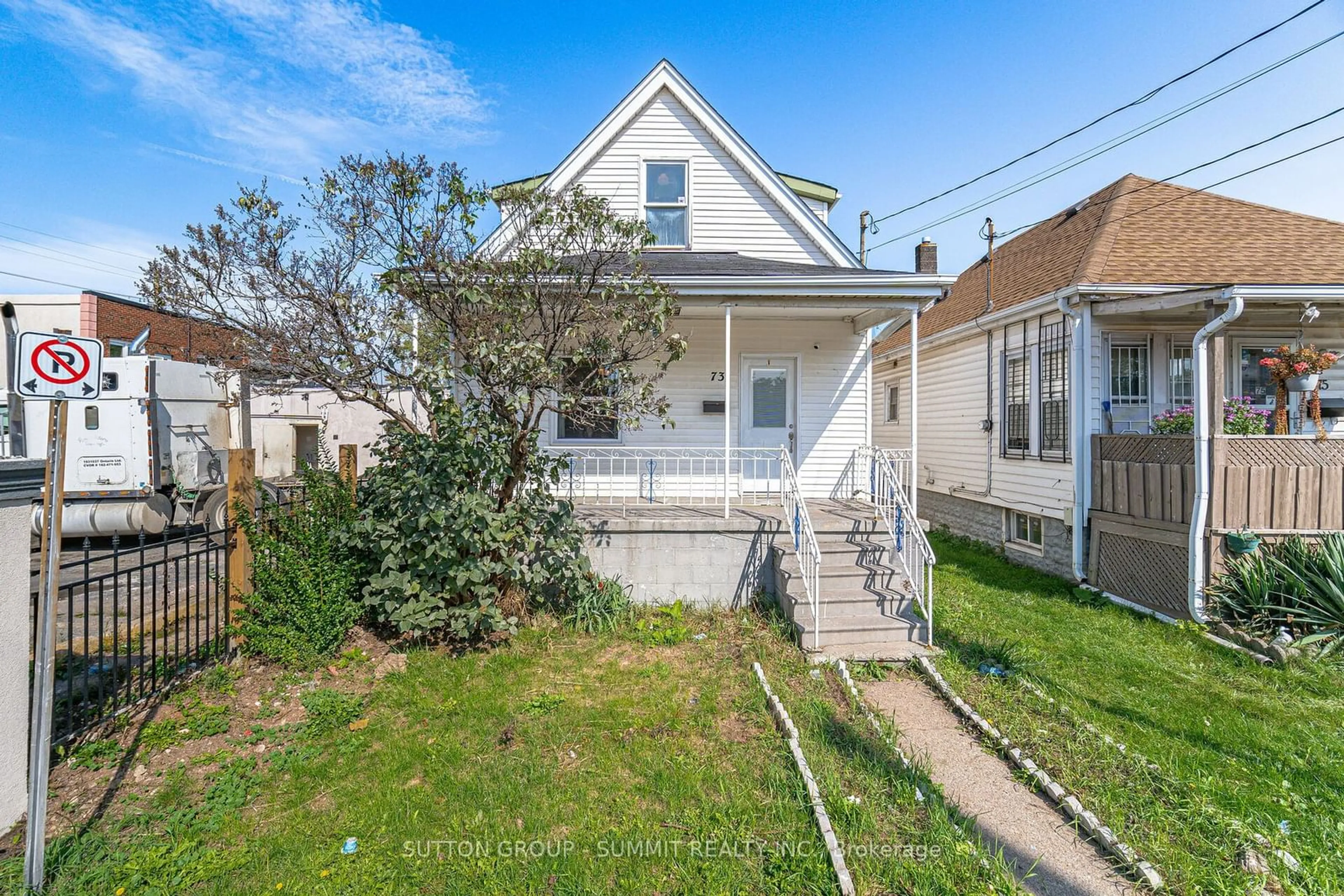 Frontside or backside of a home, the fenced backyard for 73 Hope Ave, Hamilton Ontario L8H 2E5