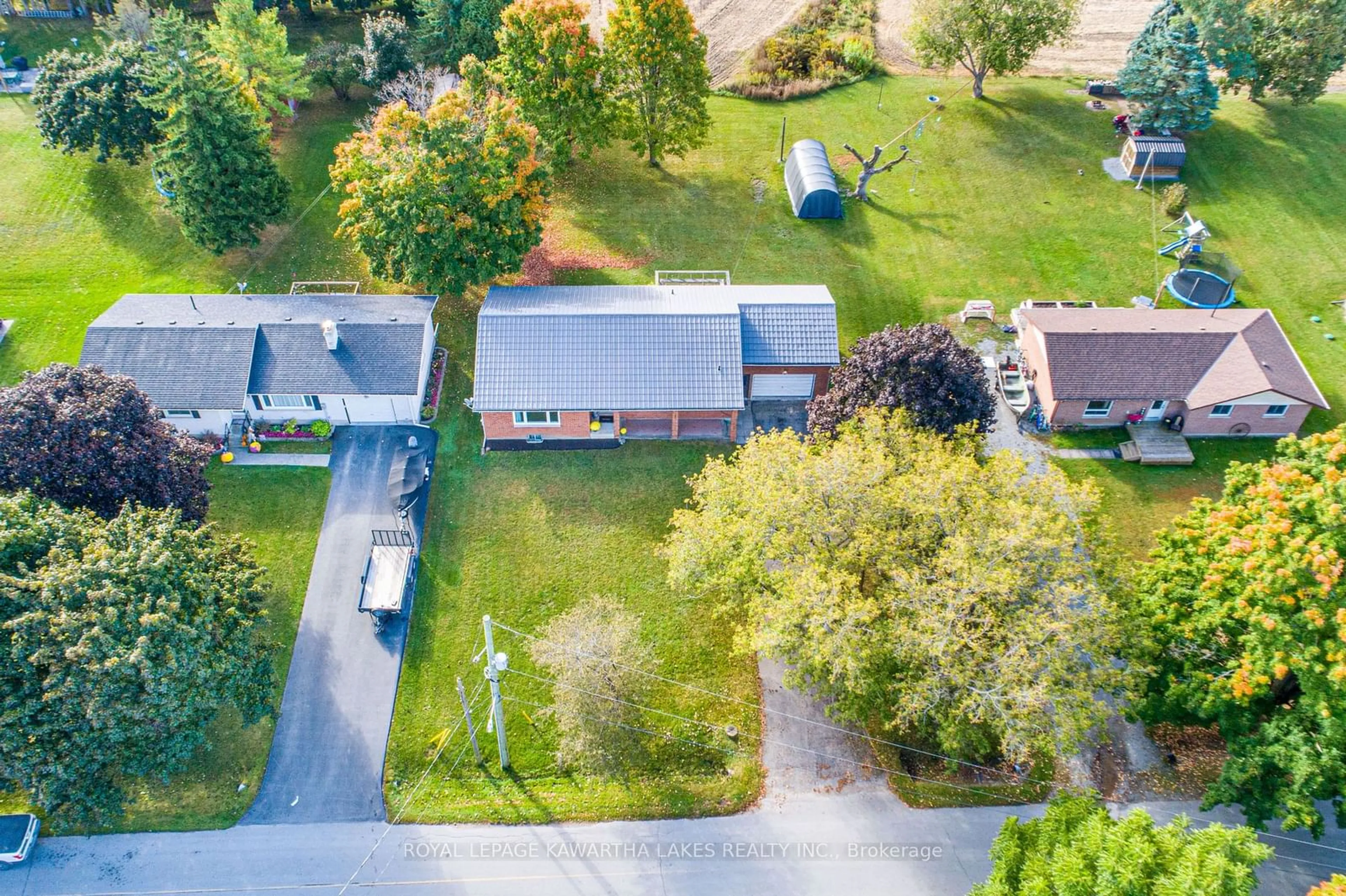 Frontside or backside of a home, the fenced backyard for 103 John St, Kawartha Lakes Ontario K0M 2T0