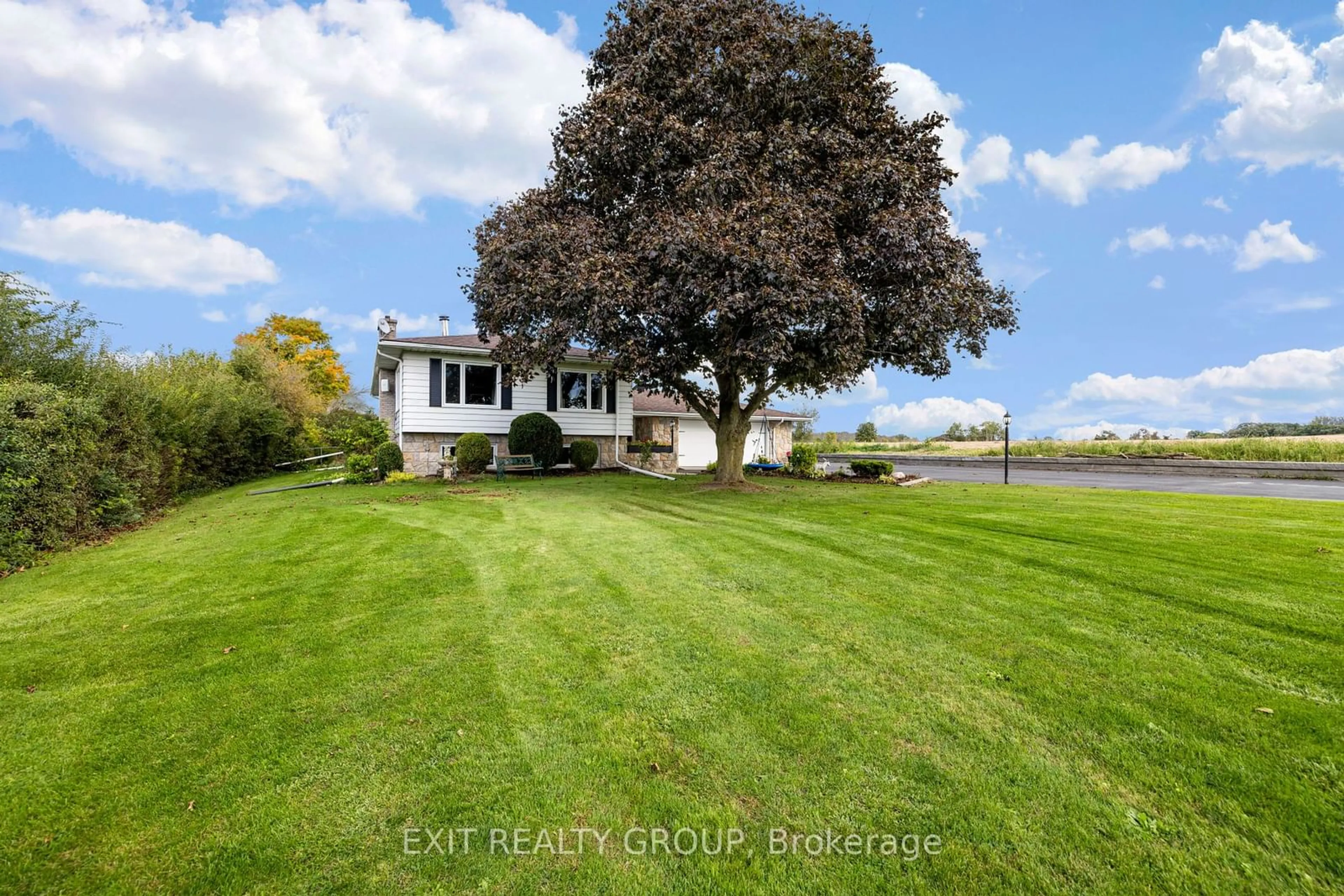 Frontside or backside of a home, the fenced backyard for 37 Dempsey Rd, Prince Edward County Ontario K0K 1L0