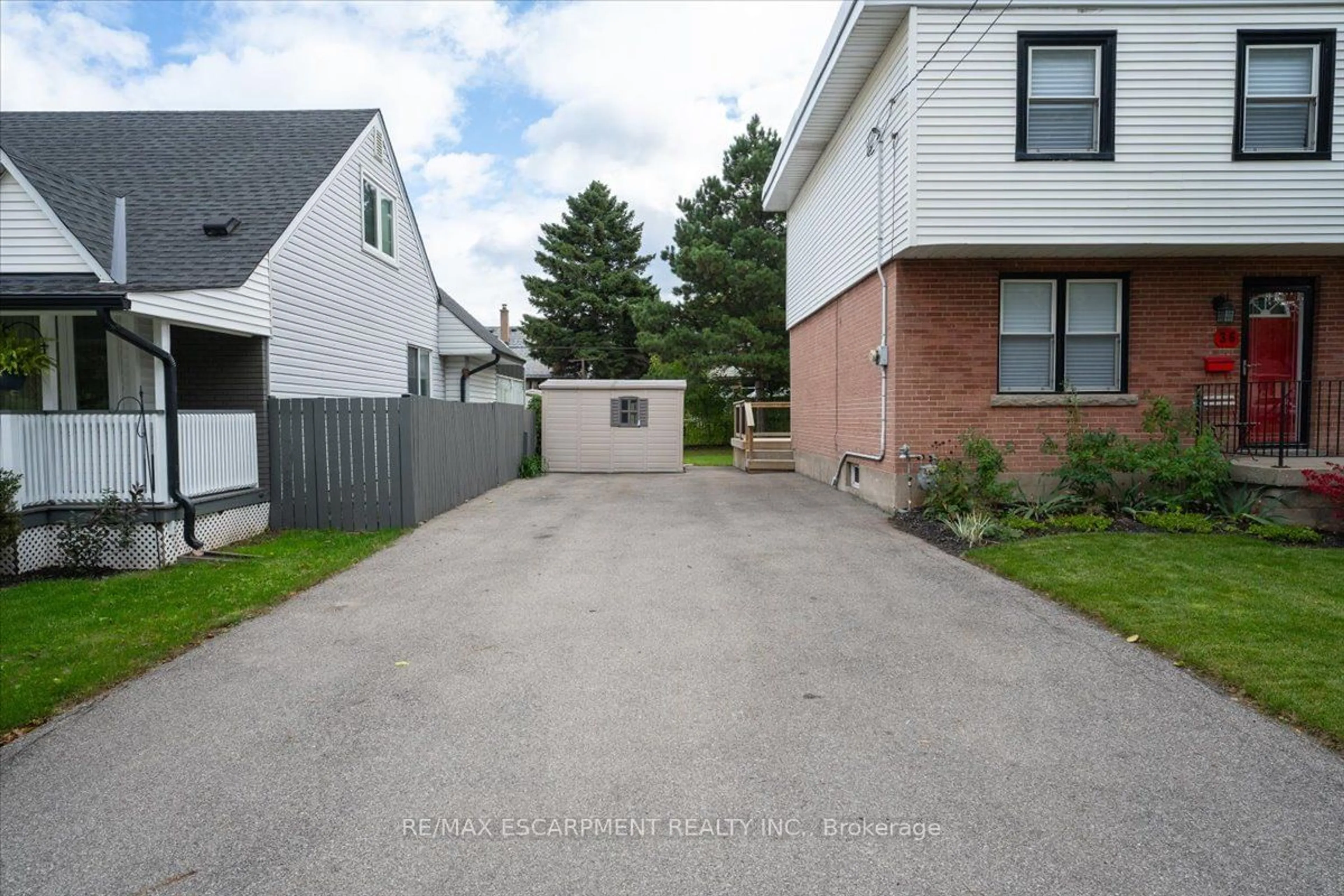 A pic from exterior of the house or condo, the fenced backyard for 36 Sumach St, Hamilton Ontario L8H 6P8