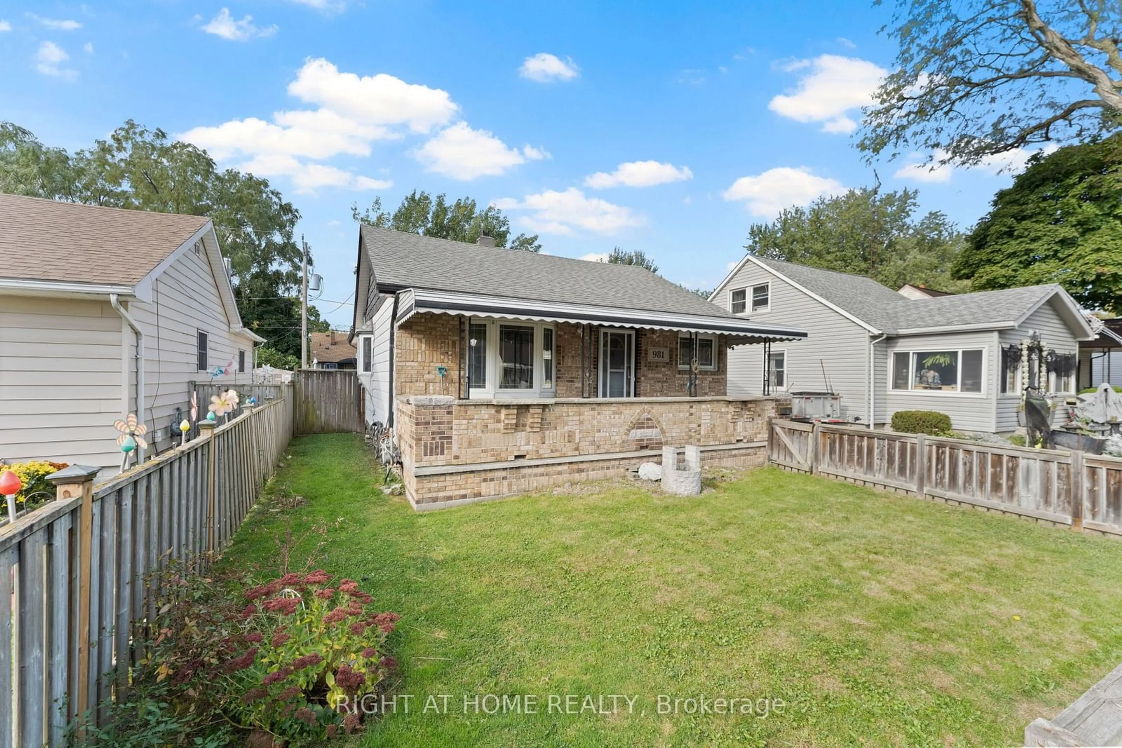 Frontside or backside of a home, the fenced backyard for 981 Partington Ave, Windsor Ontario N9B 2P1