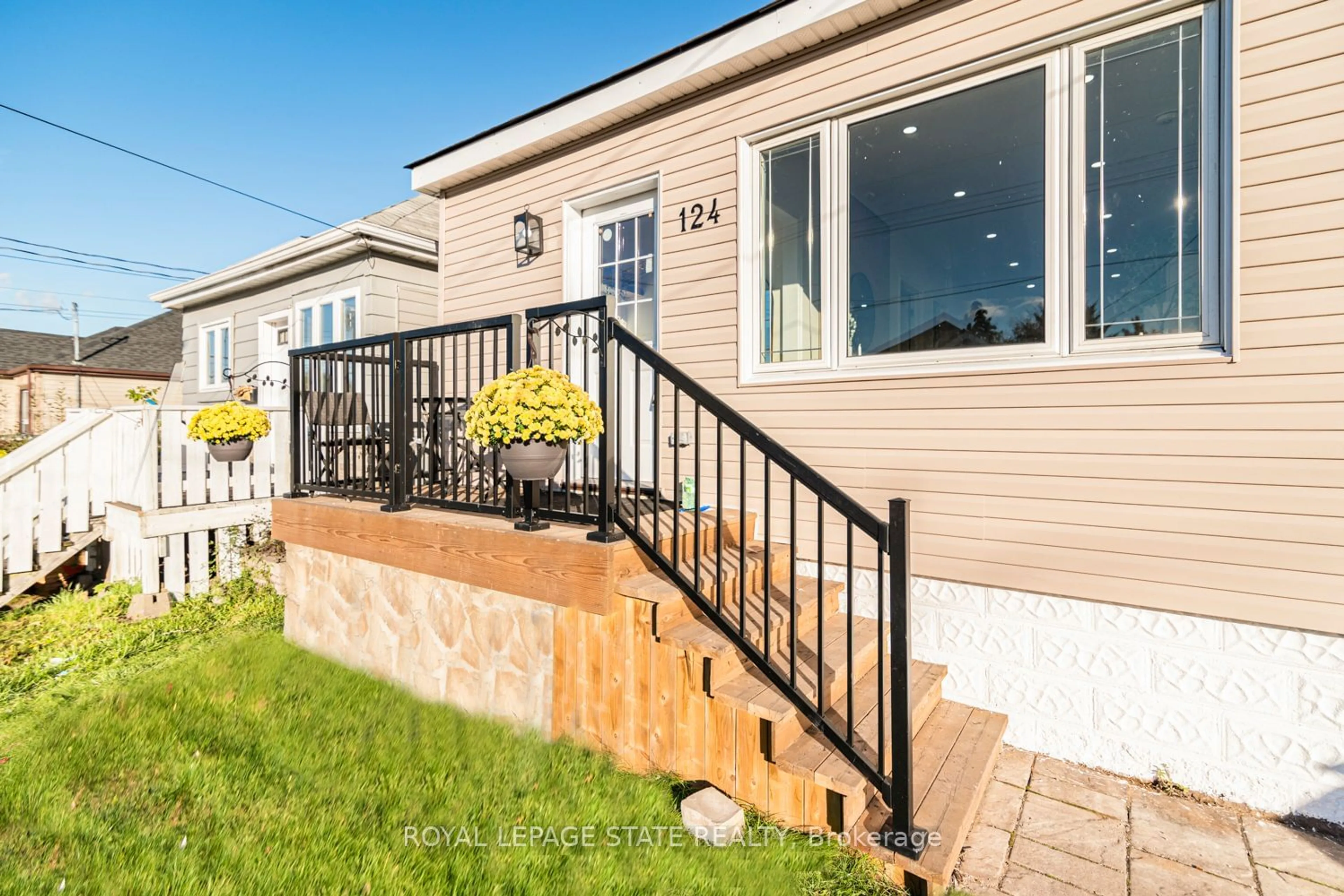 Frontside or backside of a home, the fenced backyard for 124 Harmony Ave, Hamilton Ontario L8H 4Y3