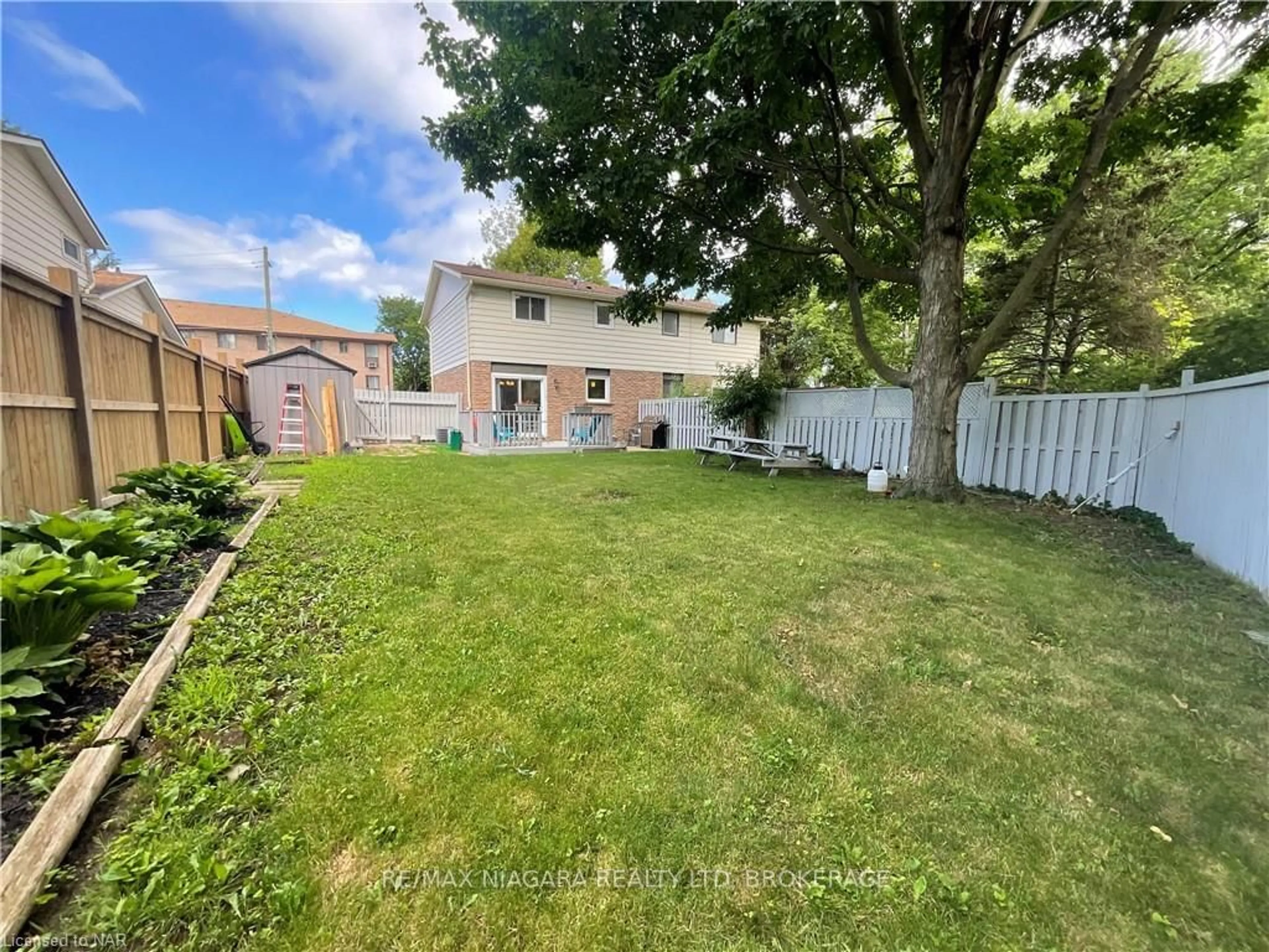 Frontside or backside of a home, the fenced backyard for 14 STOCKWELL Rd, St. Catharines Ontario L2N 6P7