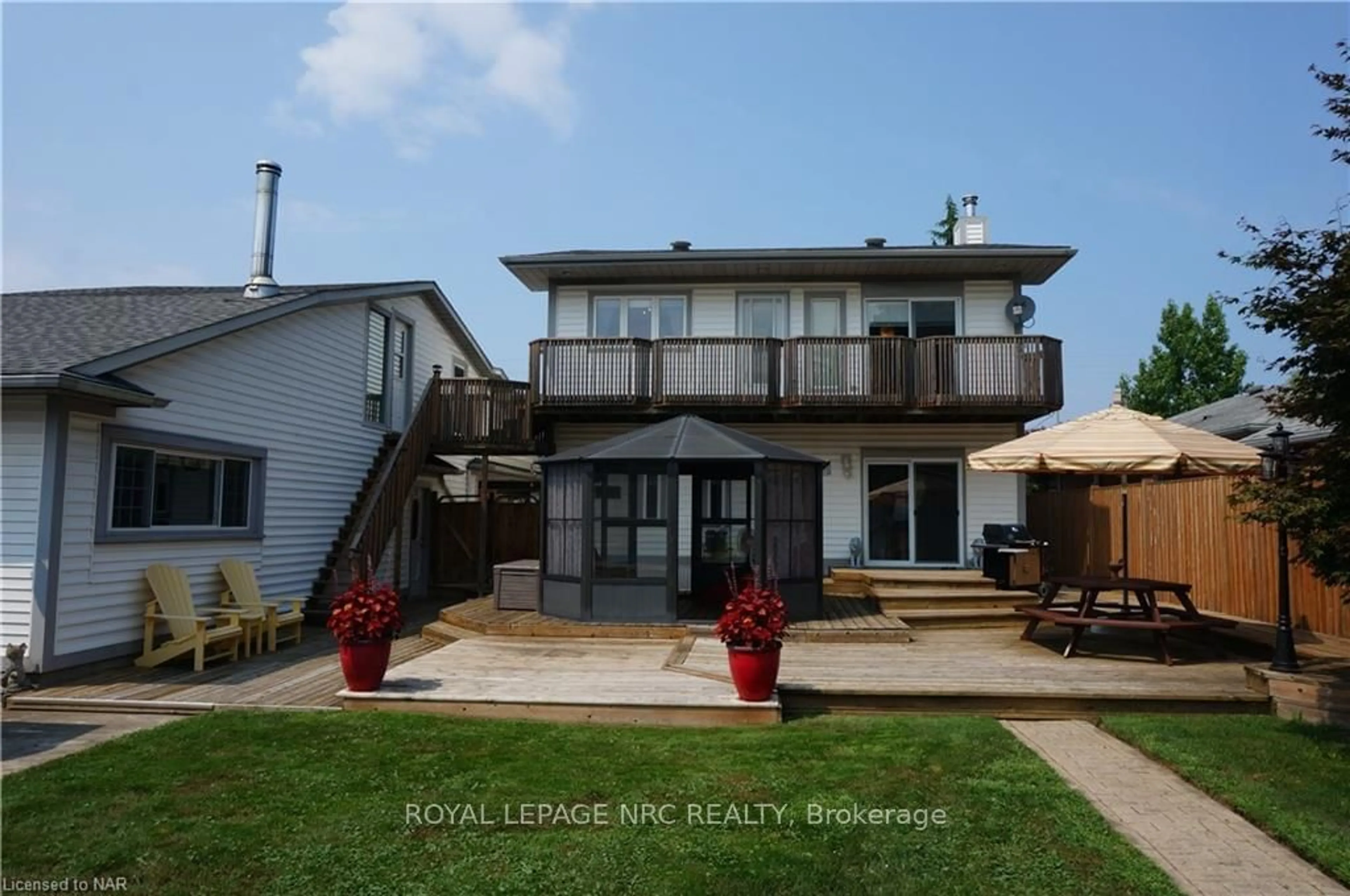 Frontside or backside of a home, the fenced backyard for 62 CECIL St, St. Catharines Ontario L2N 4B2