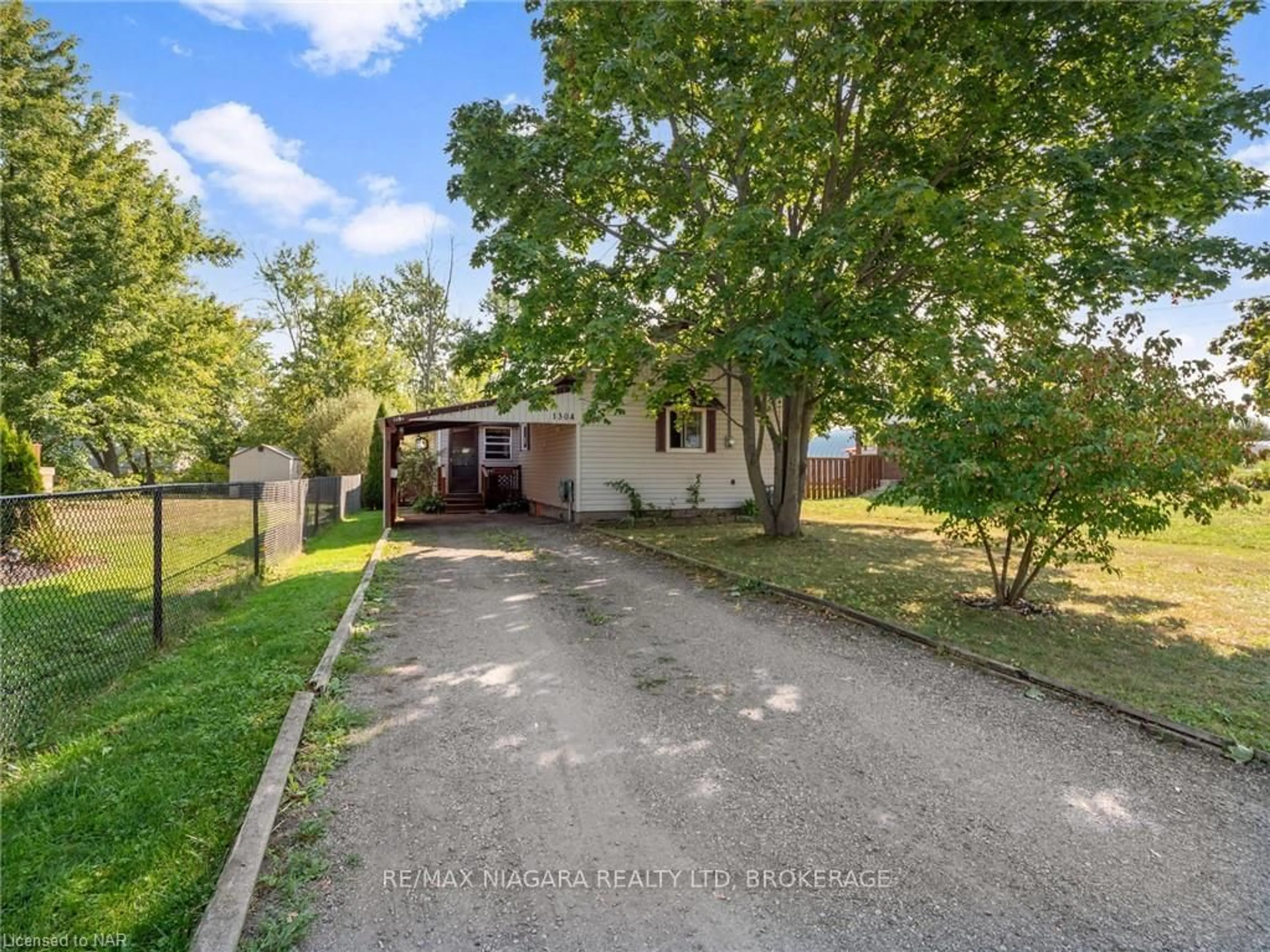 Frontside or backside of a home, the fenced backyard for 1304 SPEARS Rd, Fort Erie Ontario L2A 4N3