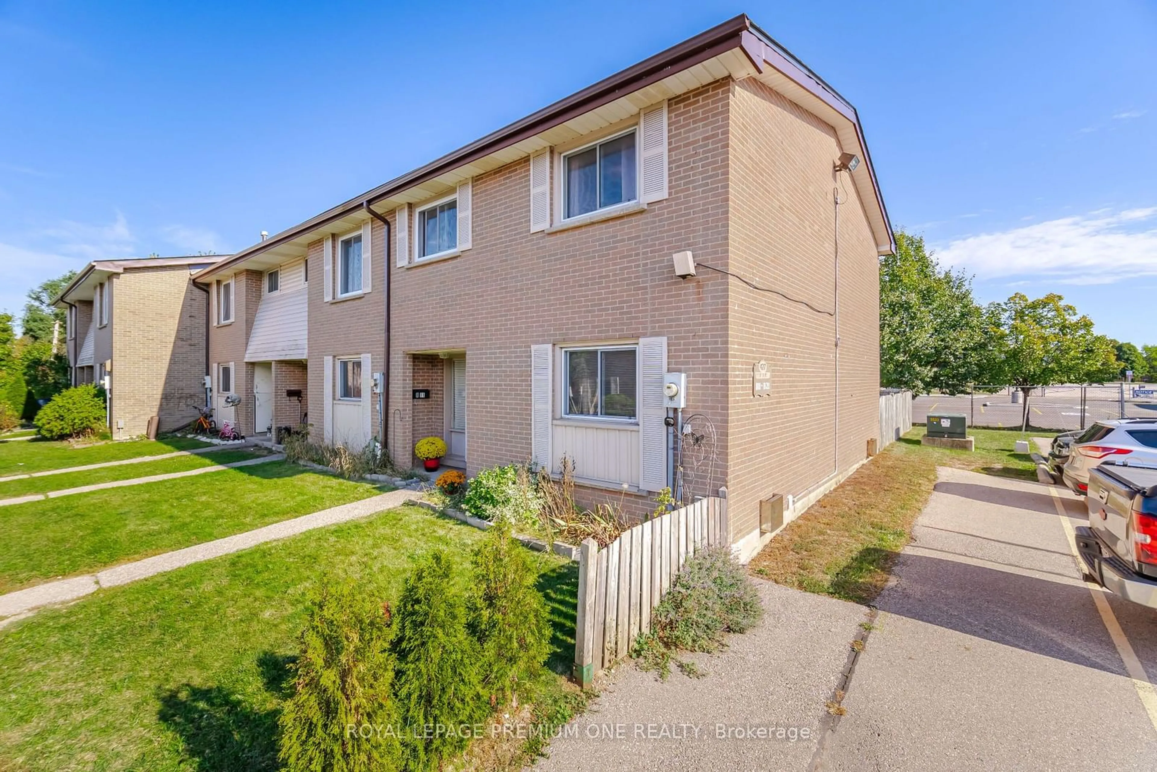 A pic from exterior of the house or condo, the fenced backyard for 427 Victoria Rd #B11, Guelph Ontario N1E 3M2