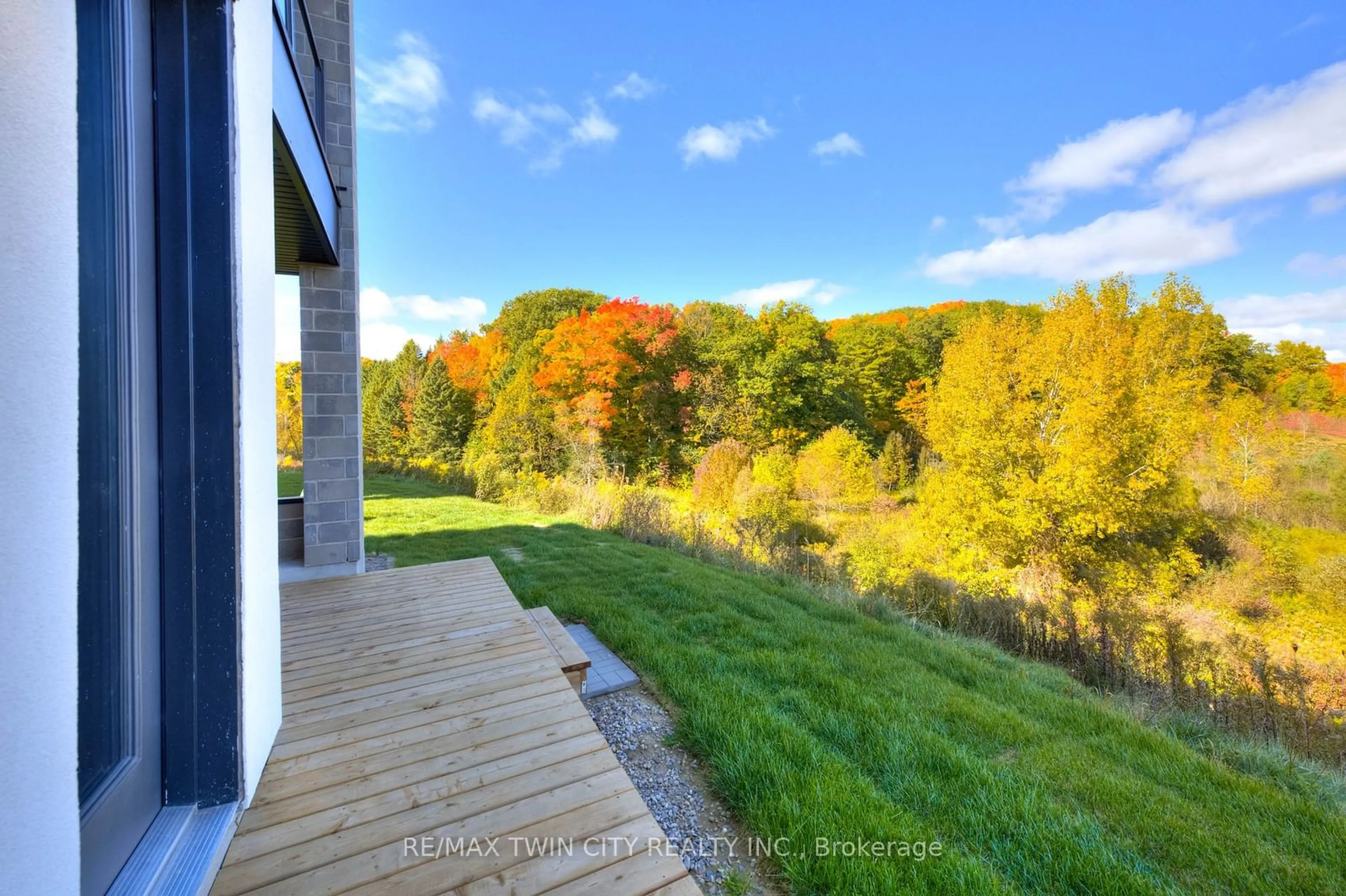 A pic from exterior of the house or condo, the fenced backyard for 261 Woodbine Ave #39, Kitchener Ontario N2R 0S7