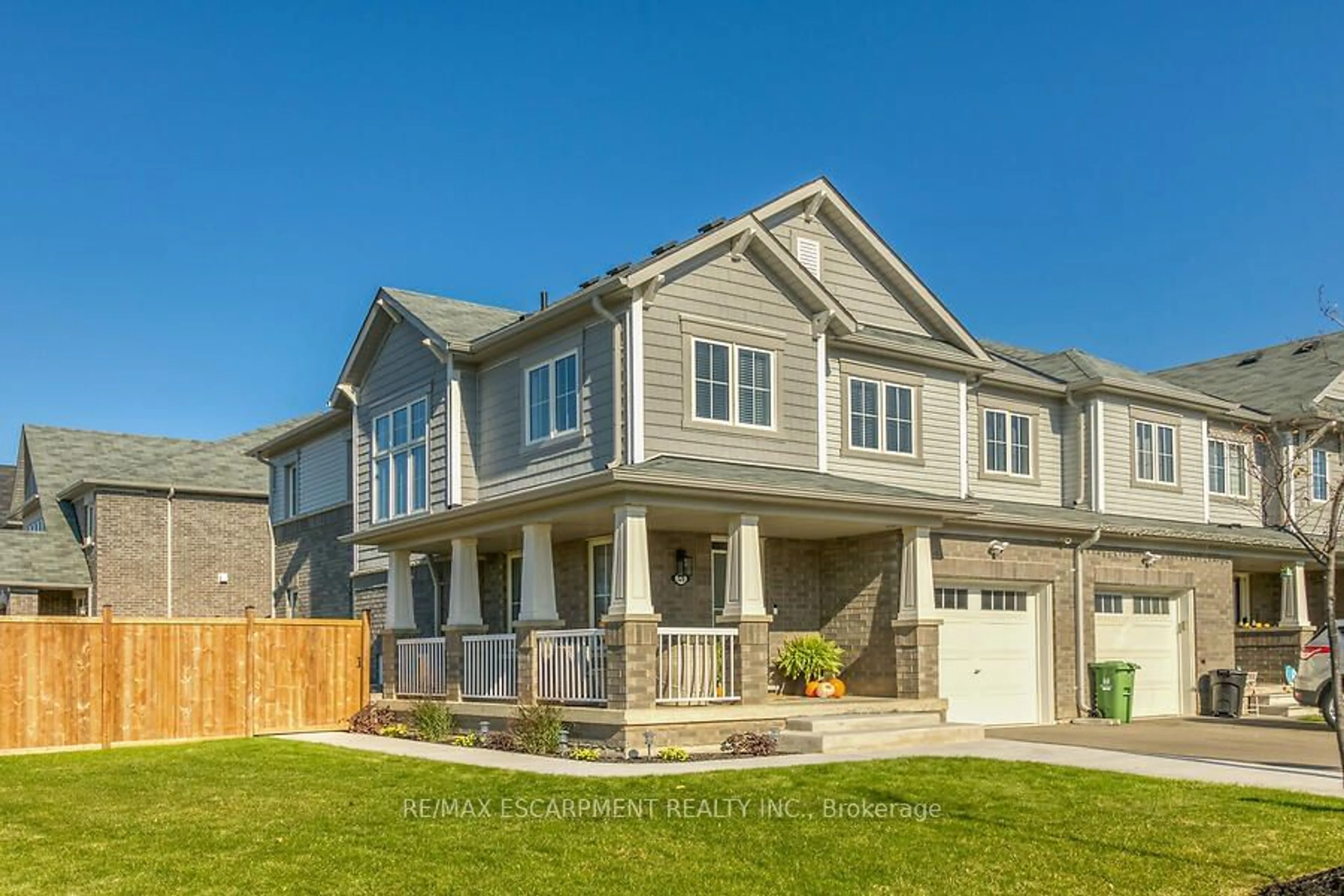 Frontside or backside of a home, the fenced backyard for 328 Pumpkin Pass, Hamilton Ontario L0R 1C0