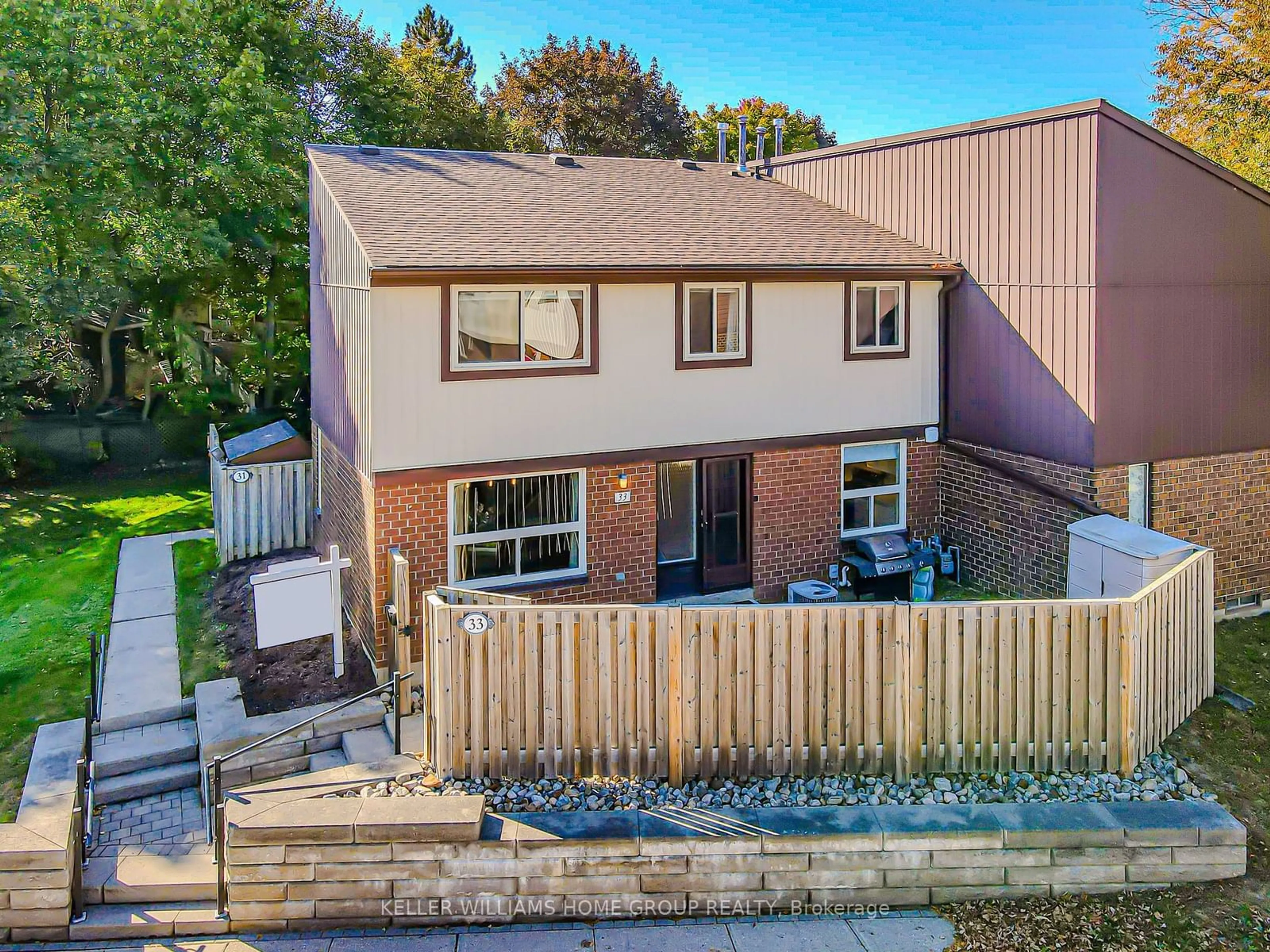 A pic from exterior of the house or condo, the fenced backyard for 45 Marksam Rd #33, Guelph Ontario N1H 6Y9