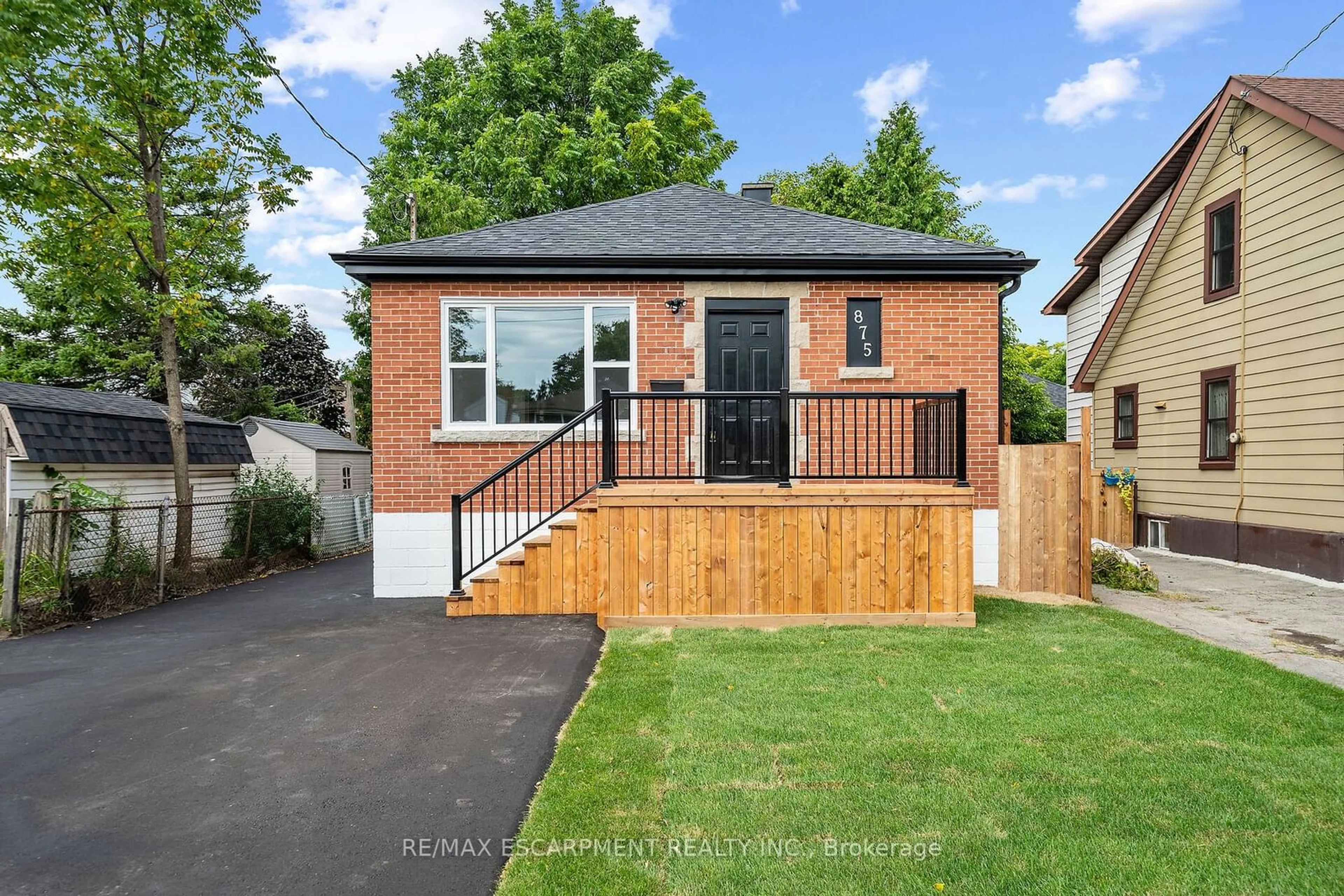 Frontside or backside of a home, the fenced backyard for 875 Fennell Ave, Hamilton Ontario L8V 1W3