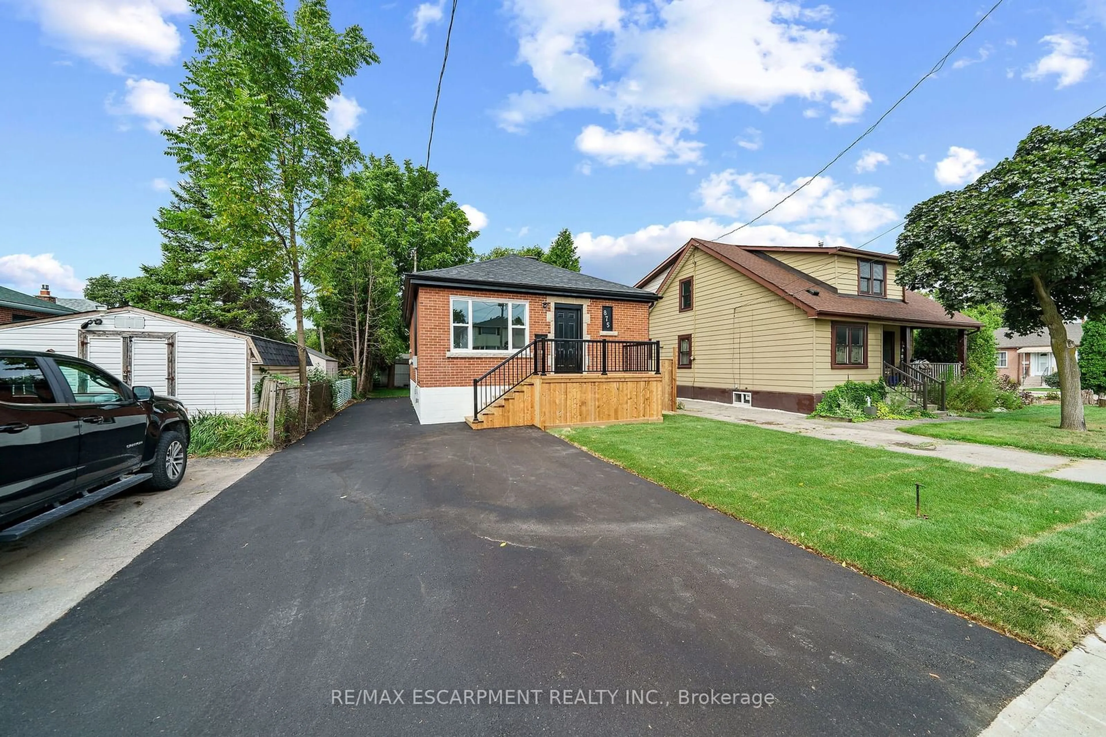 Frontside or backside of a home, the fenced backyard for 875 Fennell Ave, Hamilton Ontario L8V 1W3