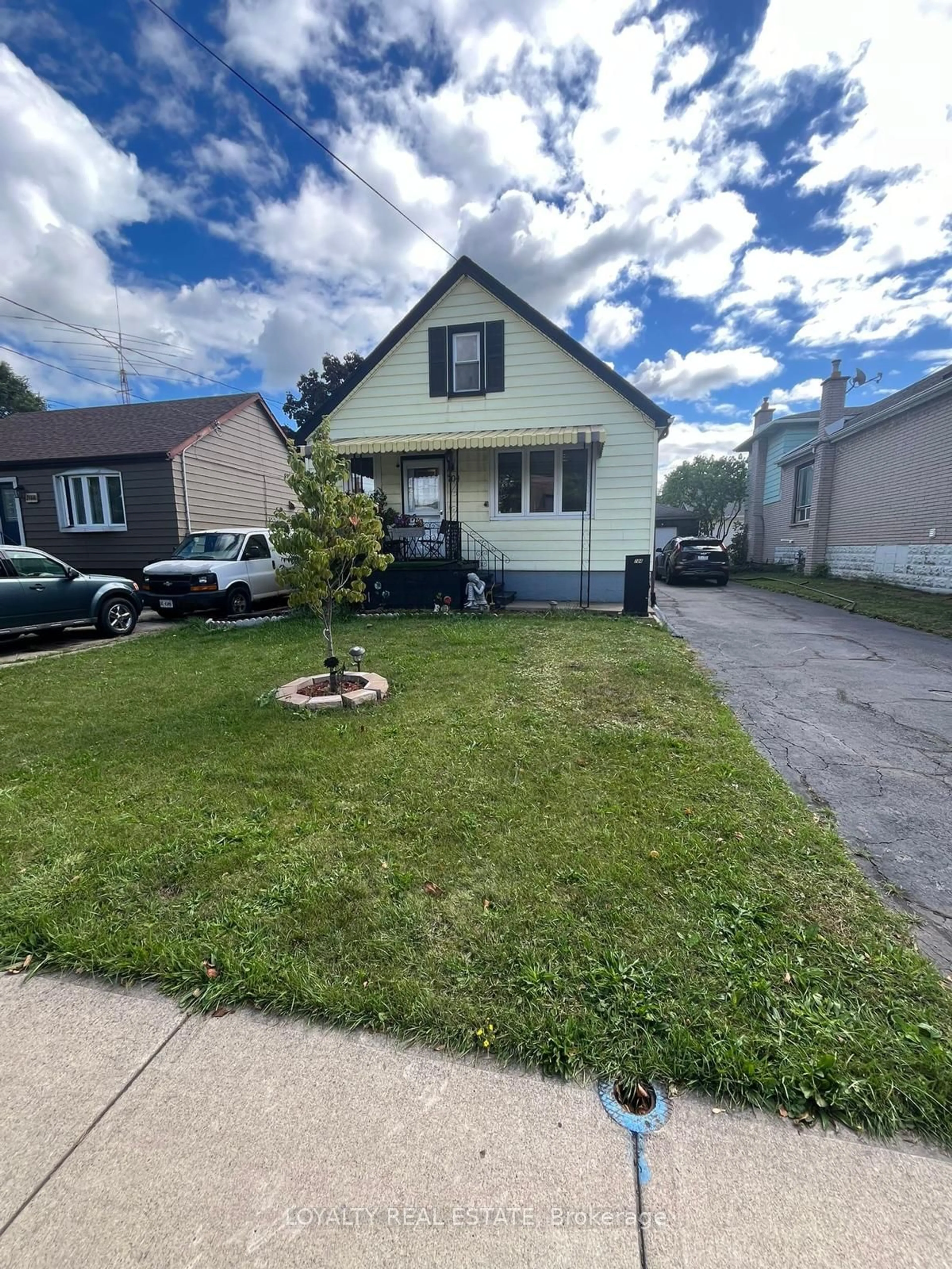 Frontside or backside of a home, the fenced backyard for 704 Burgess Ave, Hamilton Ontario L8H 6J4