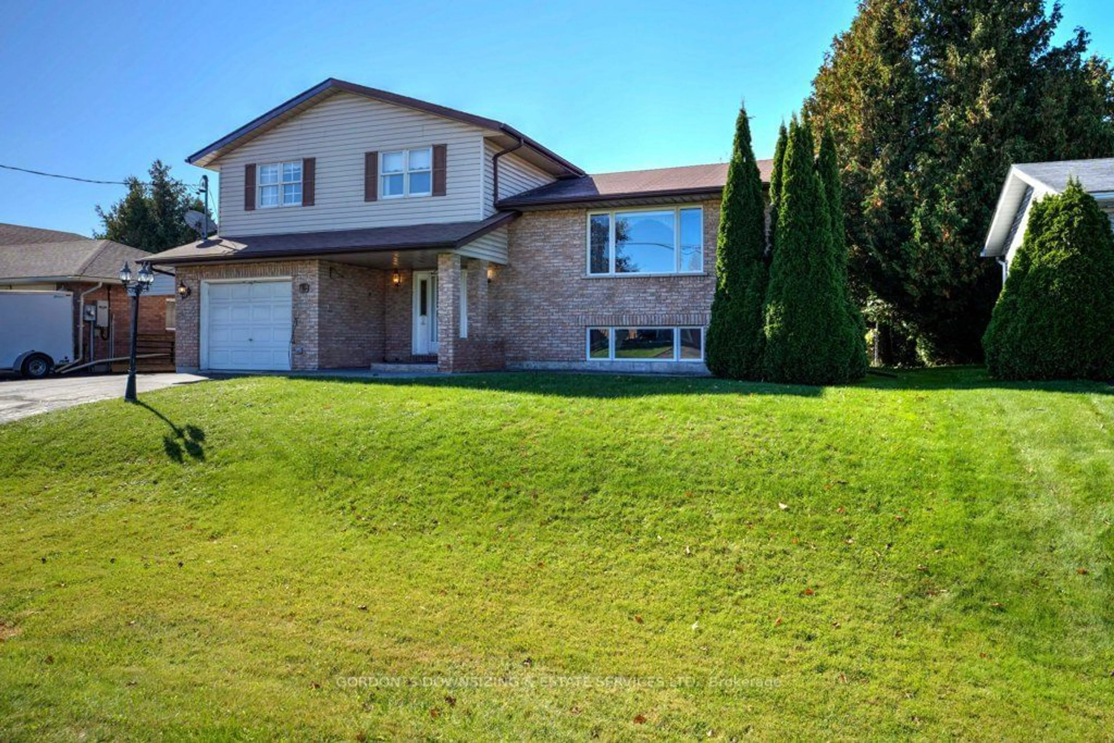 Frontside or backside of a home, the fenced backyard for 16 Walas St, Brighton Ontario K0K 1H0