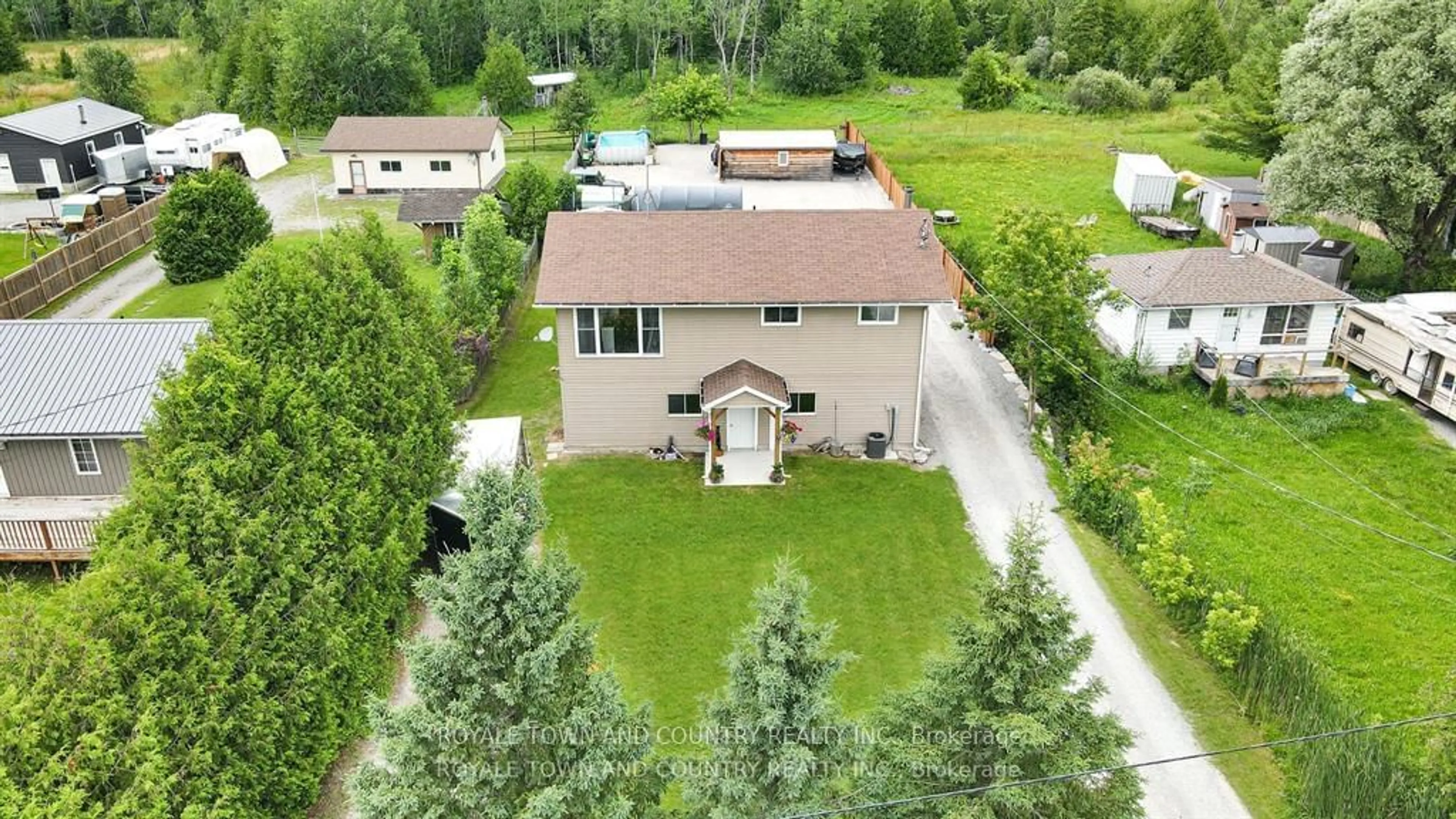 Frontside or backside of a home, the fenced backyard for 212 McGuire Beach Rd, Kawartha Lakes Ontario K0M 2B0