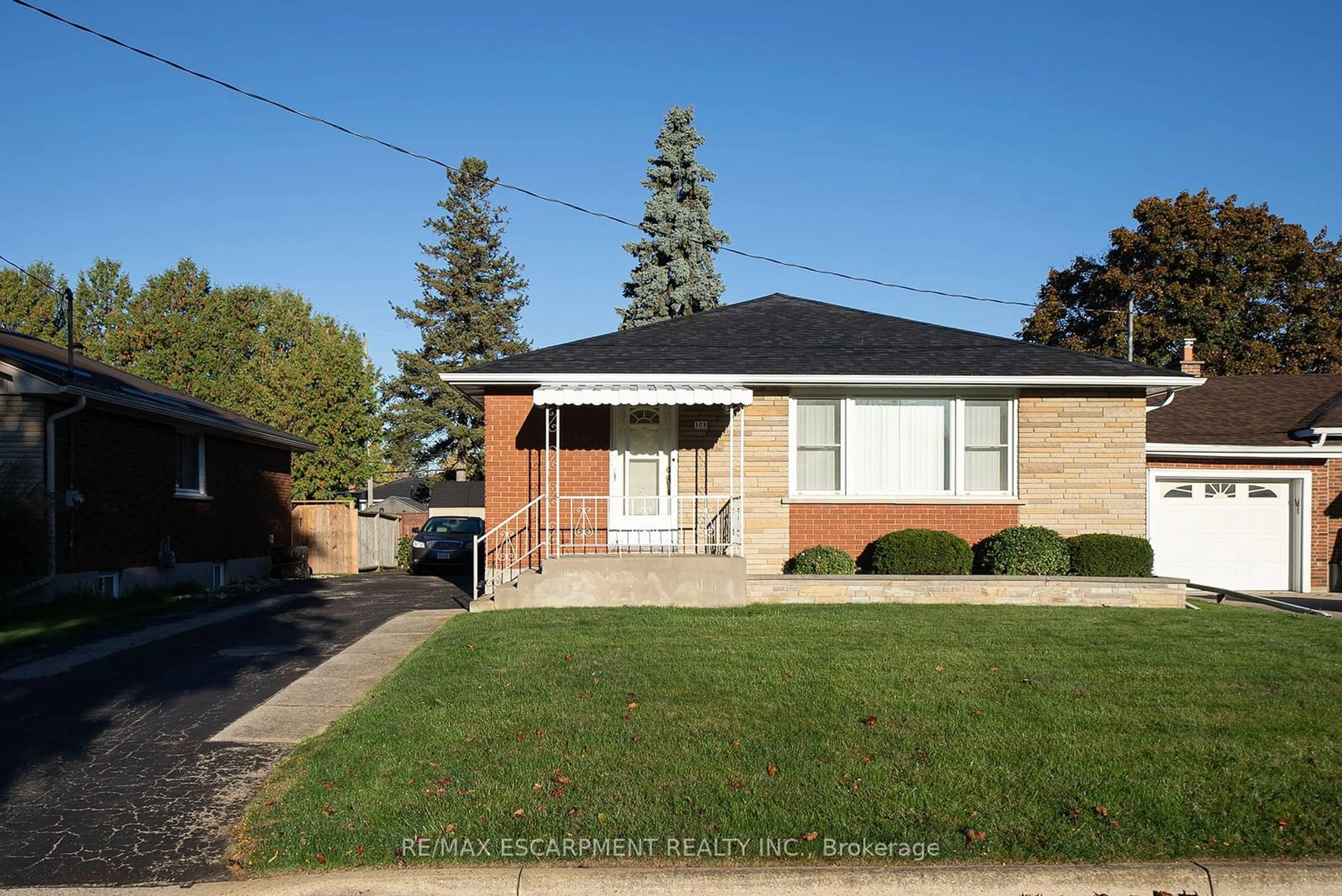 Frontside or backside of a home, the fenced backyard for 103 Eighth Ave, Brantford Ontario N3S 1C7