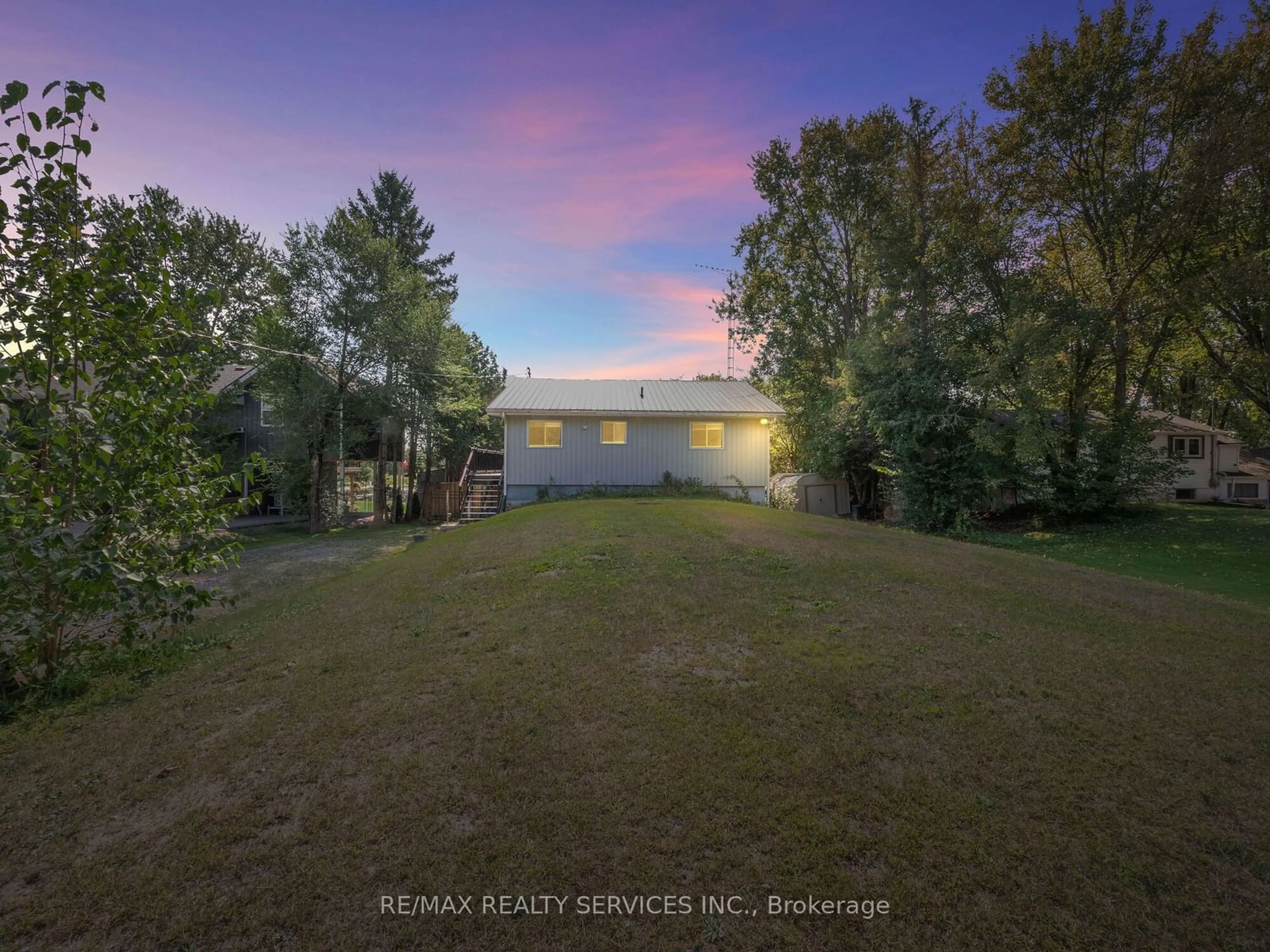 A pic from exterior of the house or condo, the fenced backyard for 183 McGuire Beach Rd, Kawartha Lakes Ontario K0M 2B0