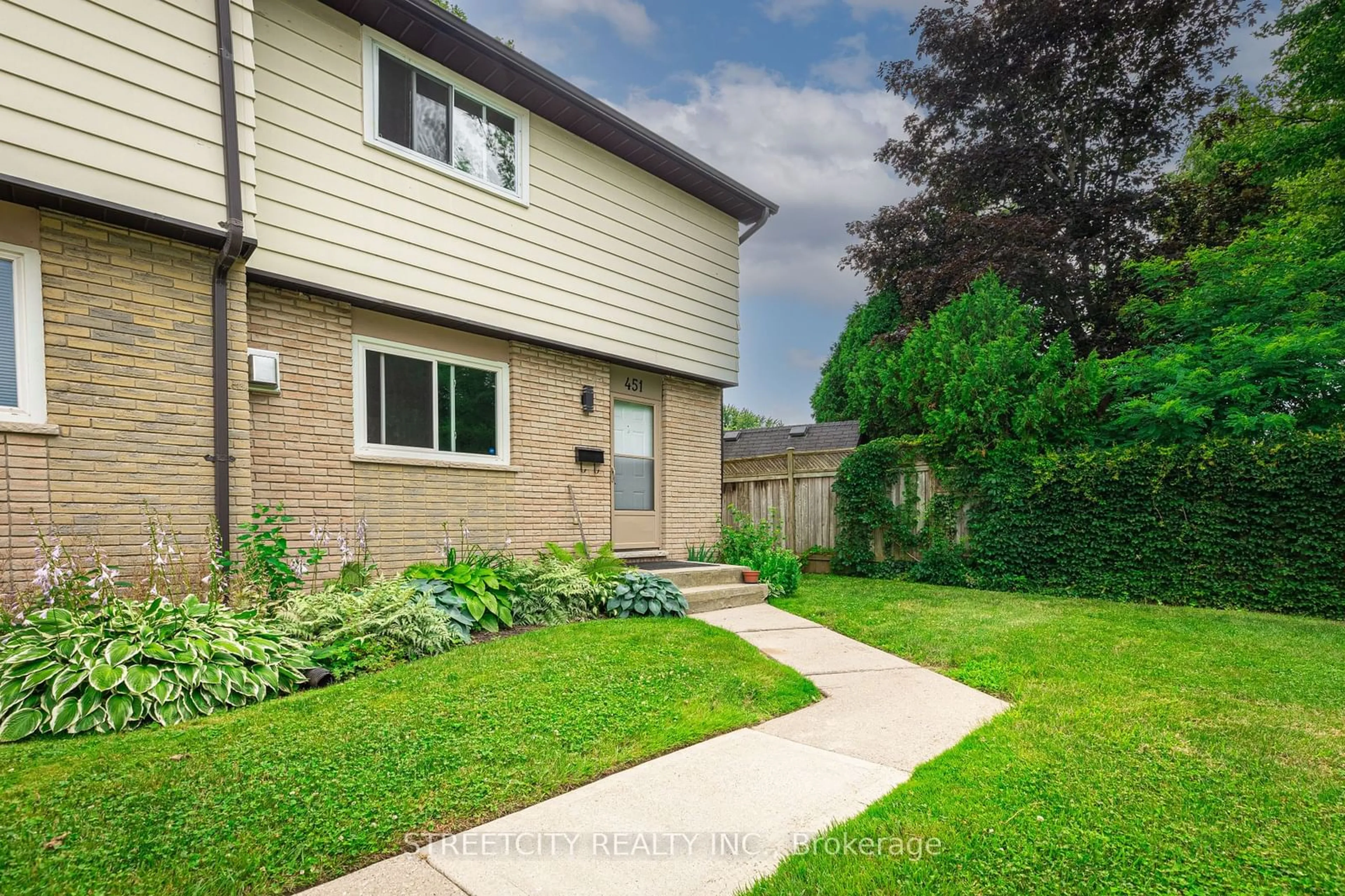 A pic from exterior of the house or condo, the fenced backyard for 451 Griffith St #19, London Ontario N6K 2S3