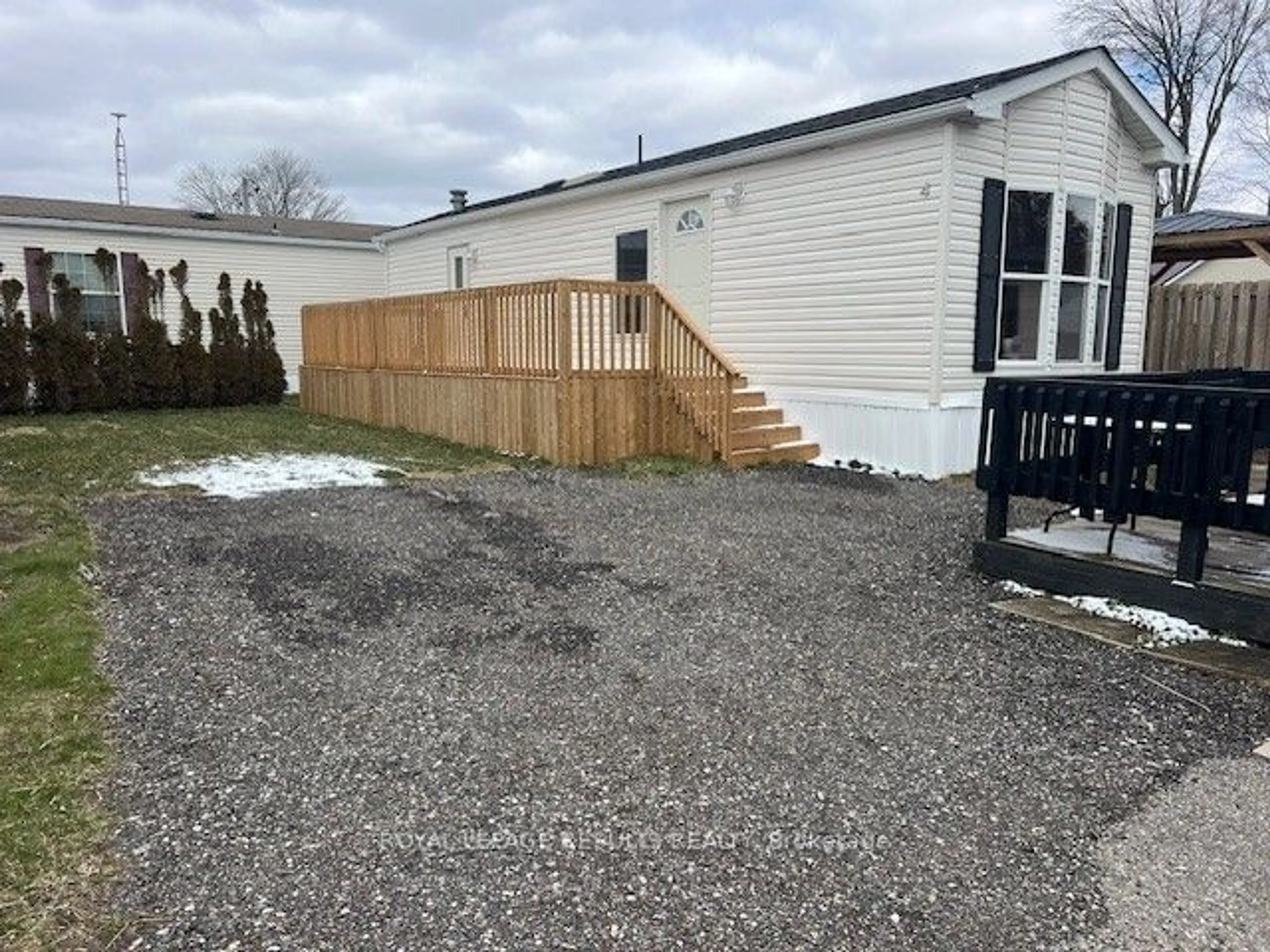 Frontside or backside of a home, the fenced backyard for 33 Pitt St #4, Bayham Ontario N0L 1T0