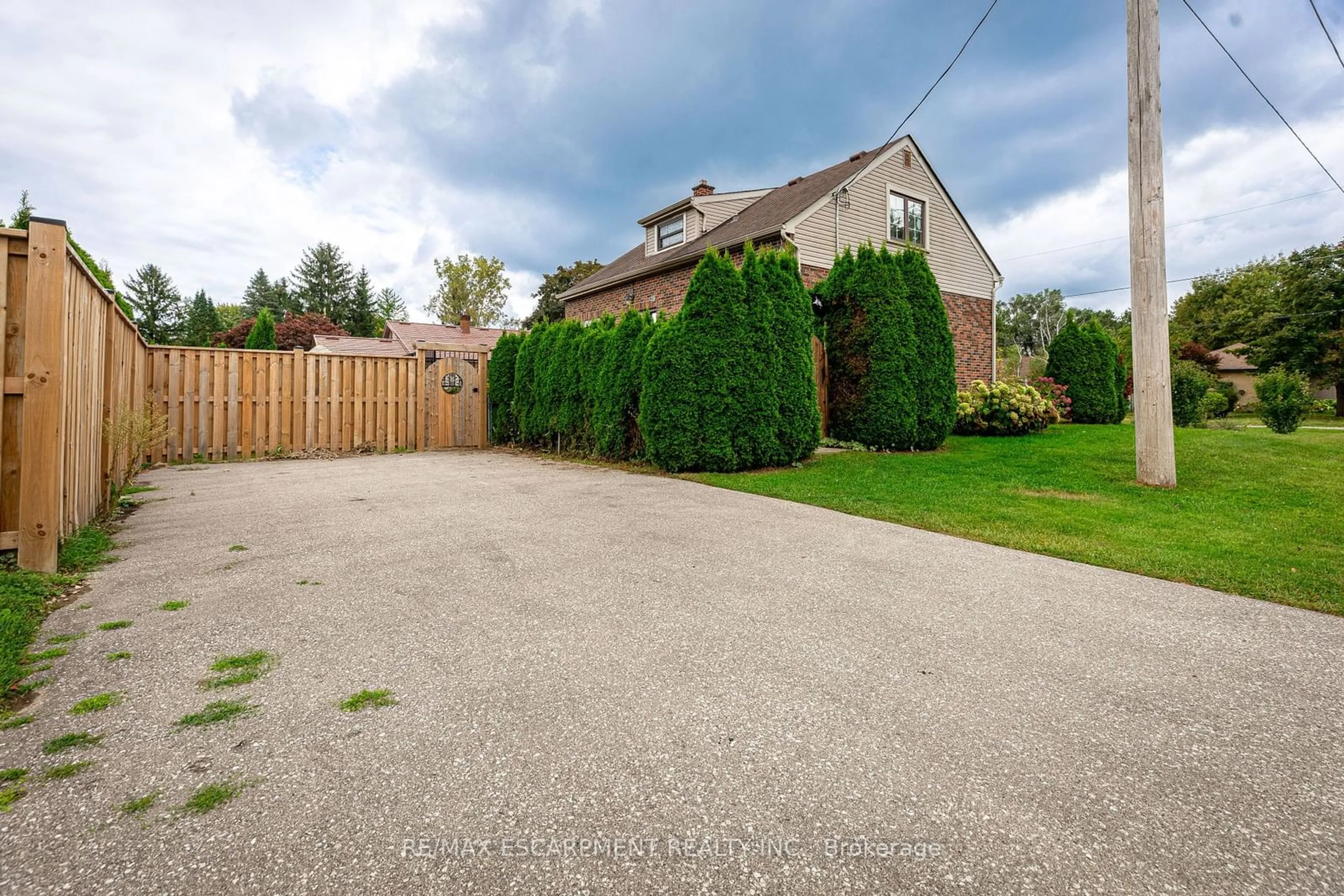 Frontside or backside of a home, the fenced backyard for 1454 Oakdale St, London Ontario N5X 1J6