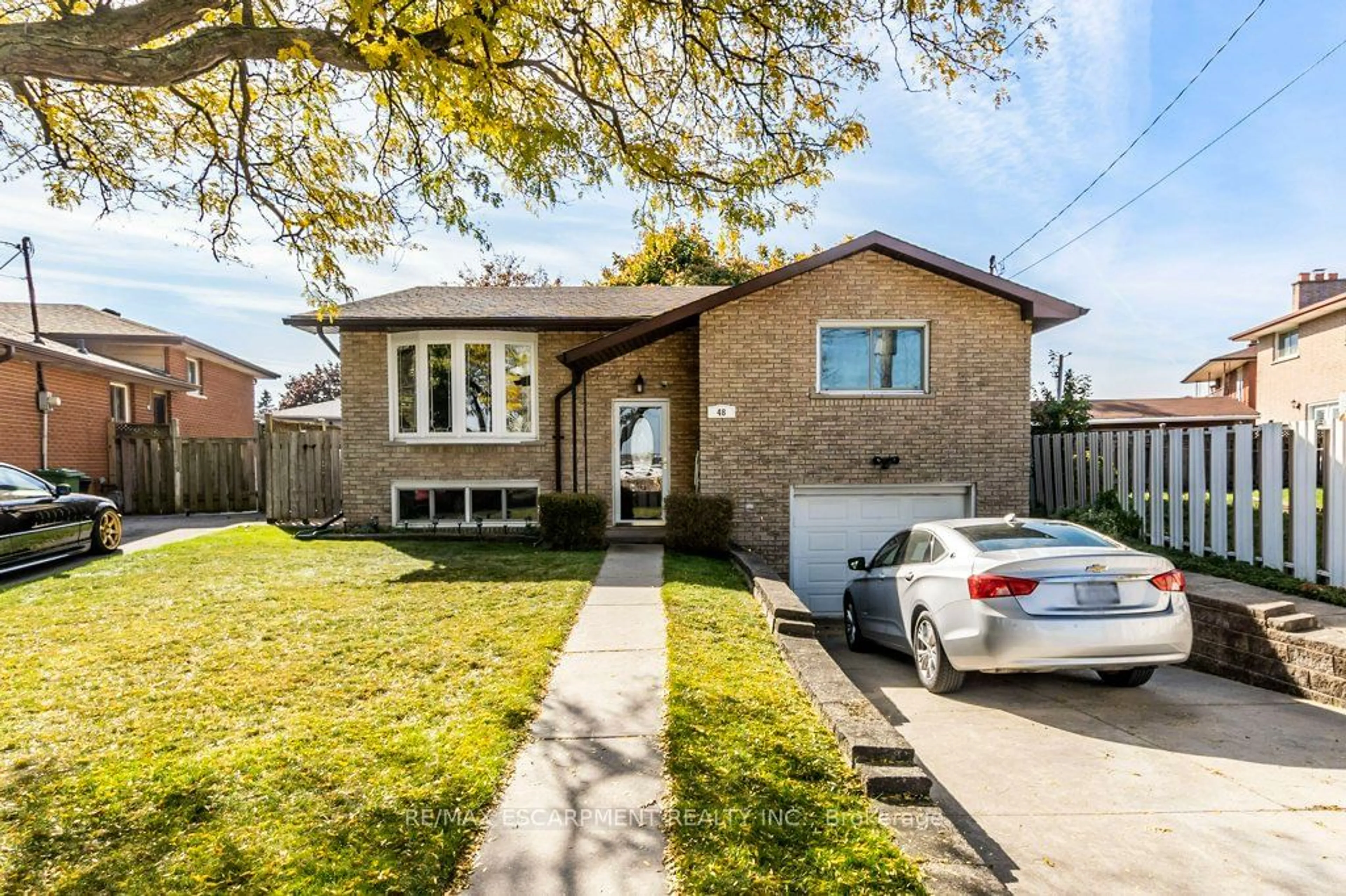 Frontside or backside of a home, the fenced backyard for 48 Tunbridge Cres, Hamilton Ontario L8W 1L2