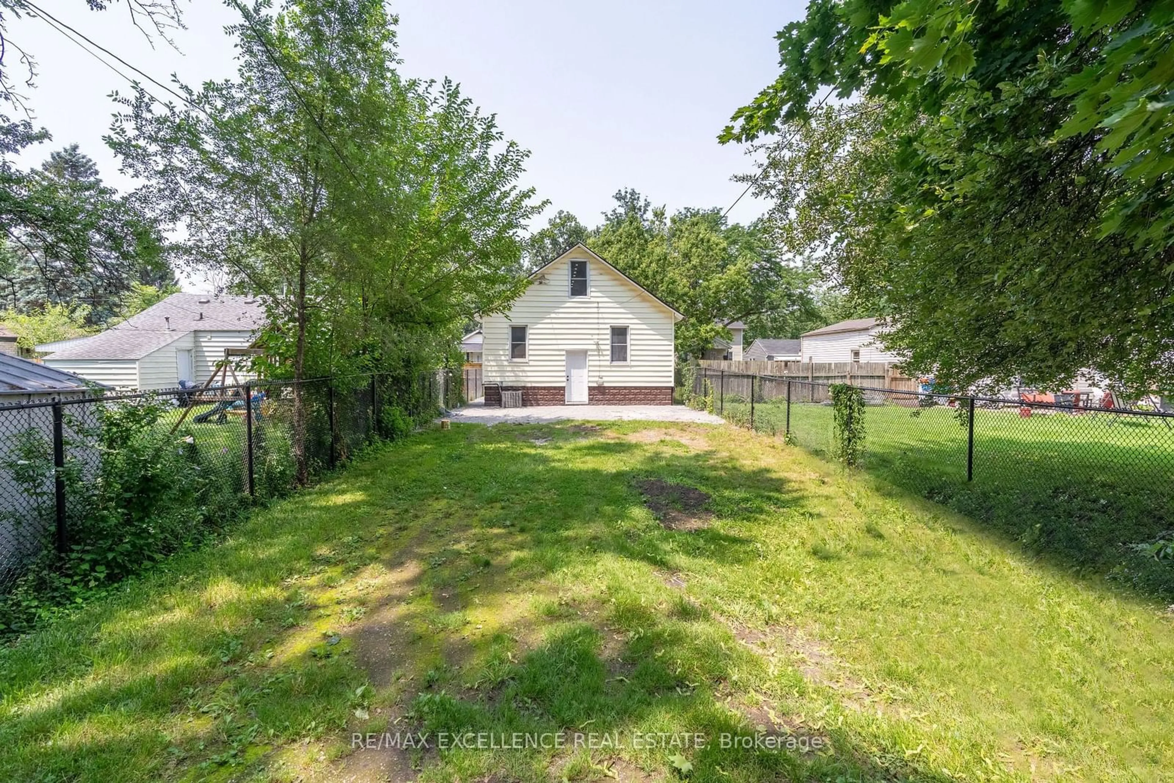 Frontside or backside of a home, the fenced backyard for 3561 King St, Windsor Ontario N9C 1P4