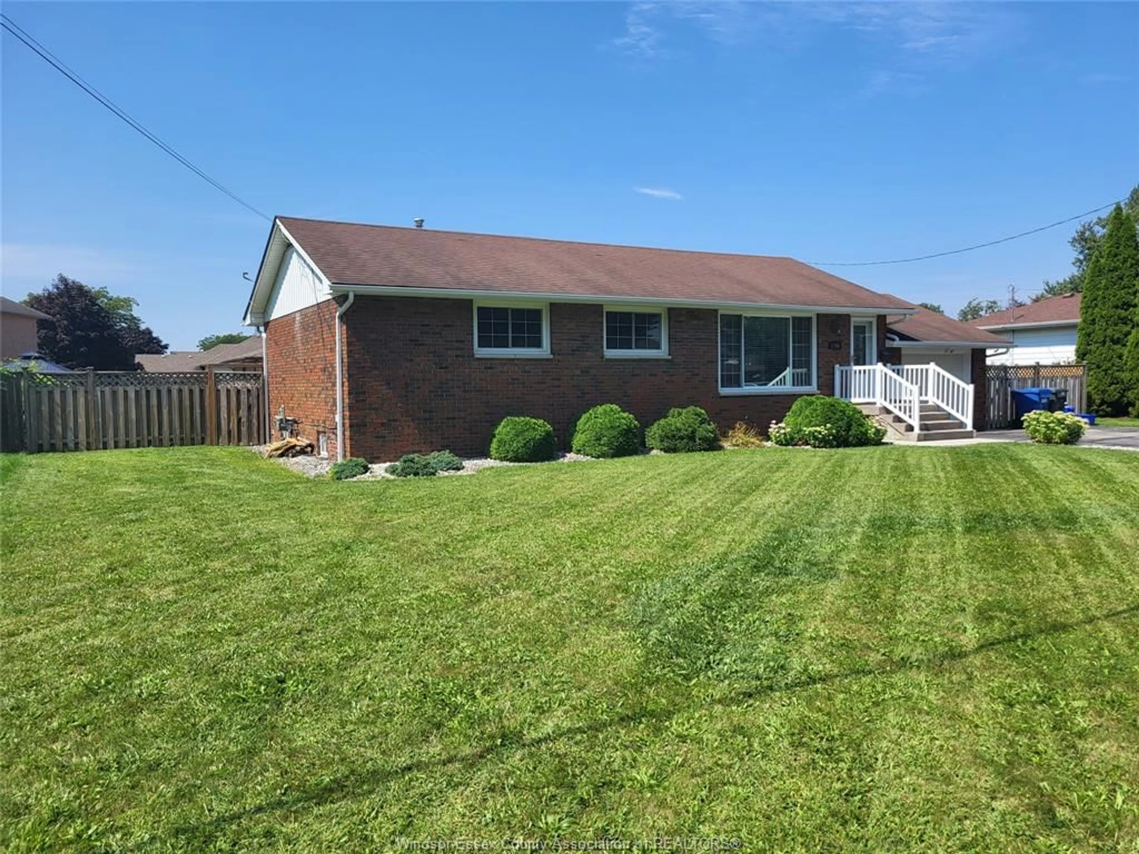 Frontside or backside of a home, the fenced backyard for 1765 SHAWNEE Rd, Tecumseh Ontario N8N 1S4