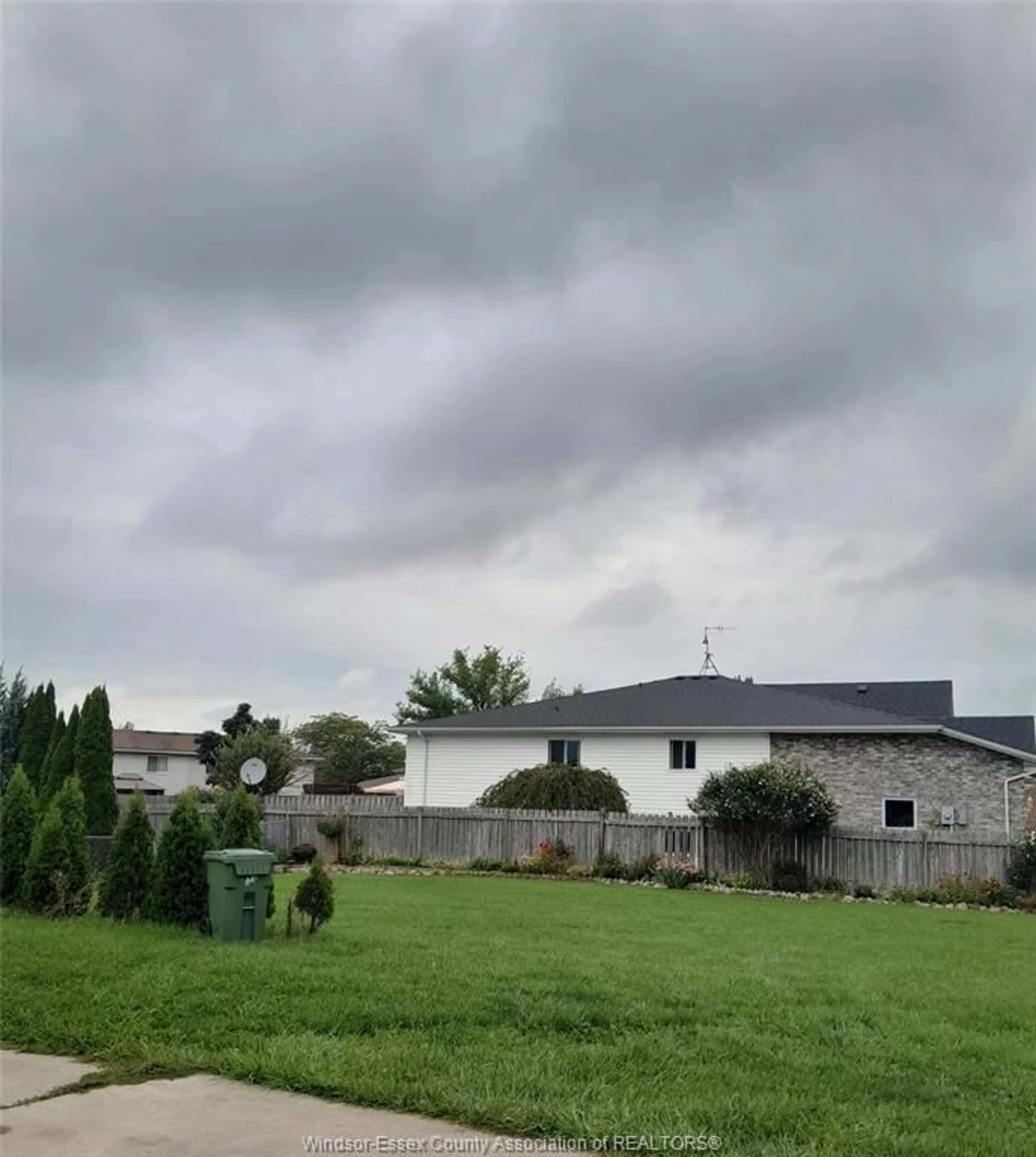 Frontside or backside of a home, the fenced backyard for 73 Sutton, Leamington Ontario N8H 5K5