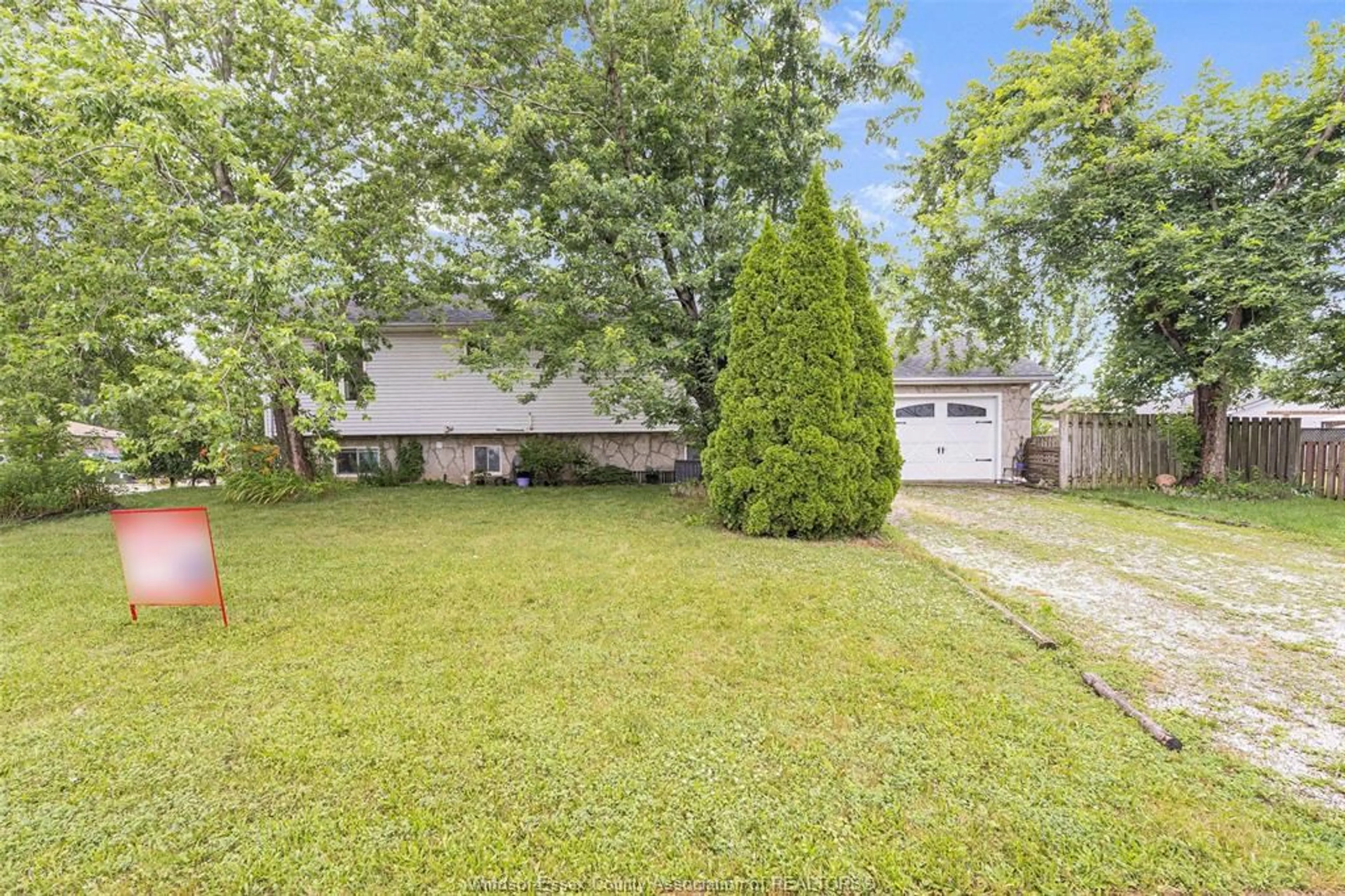 Frontside or backside of a home, the fenced backyard for 283 MAPLE St, Harrow Ontario N0R 1G0