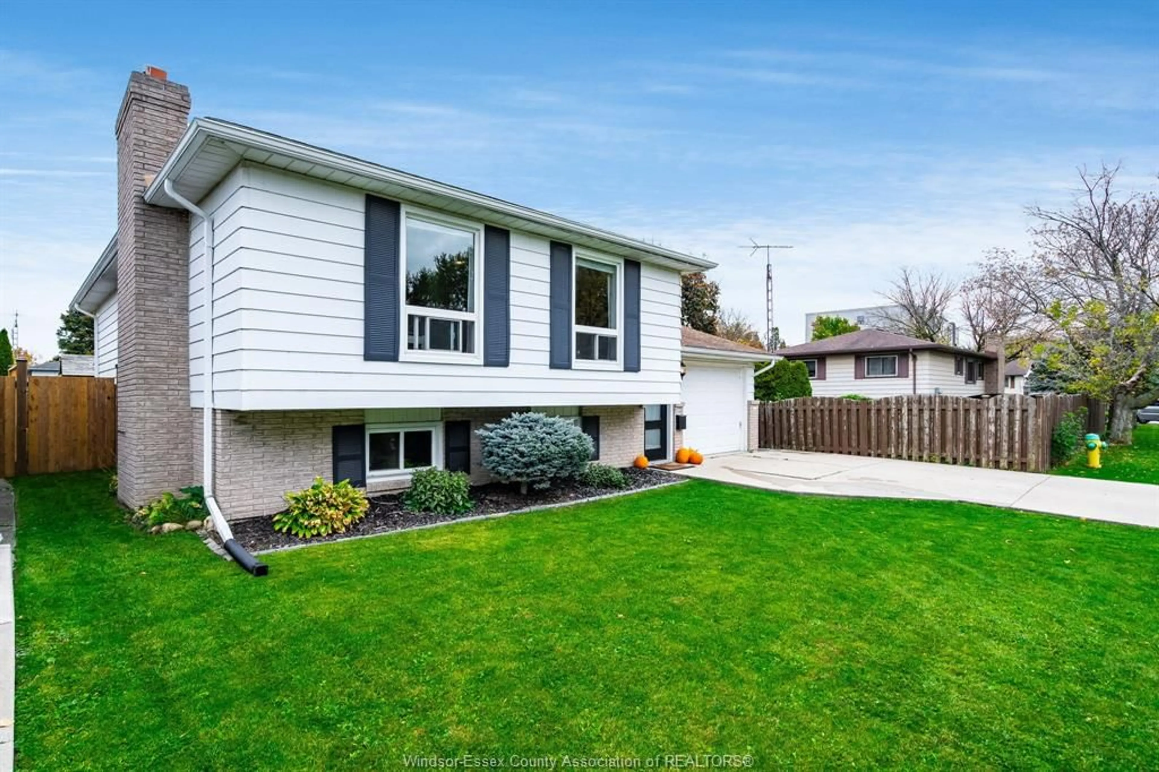 Frontside or backside of a home, the fenced backyard for 83 Woodycrest Ave, Kingsville Ontario N9Y 3P7