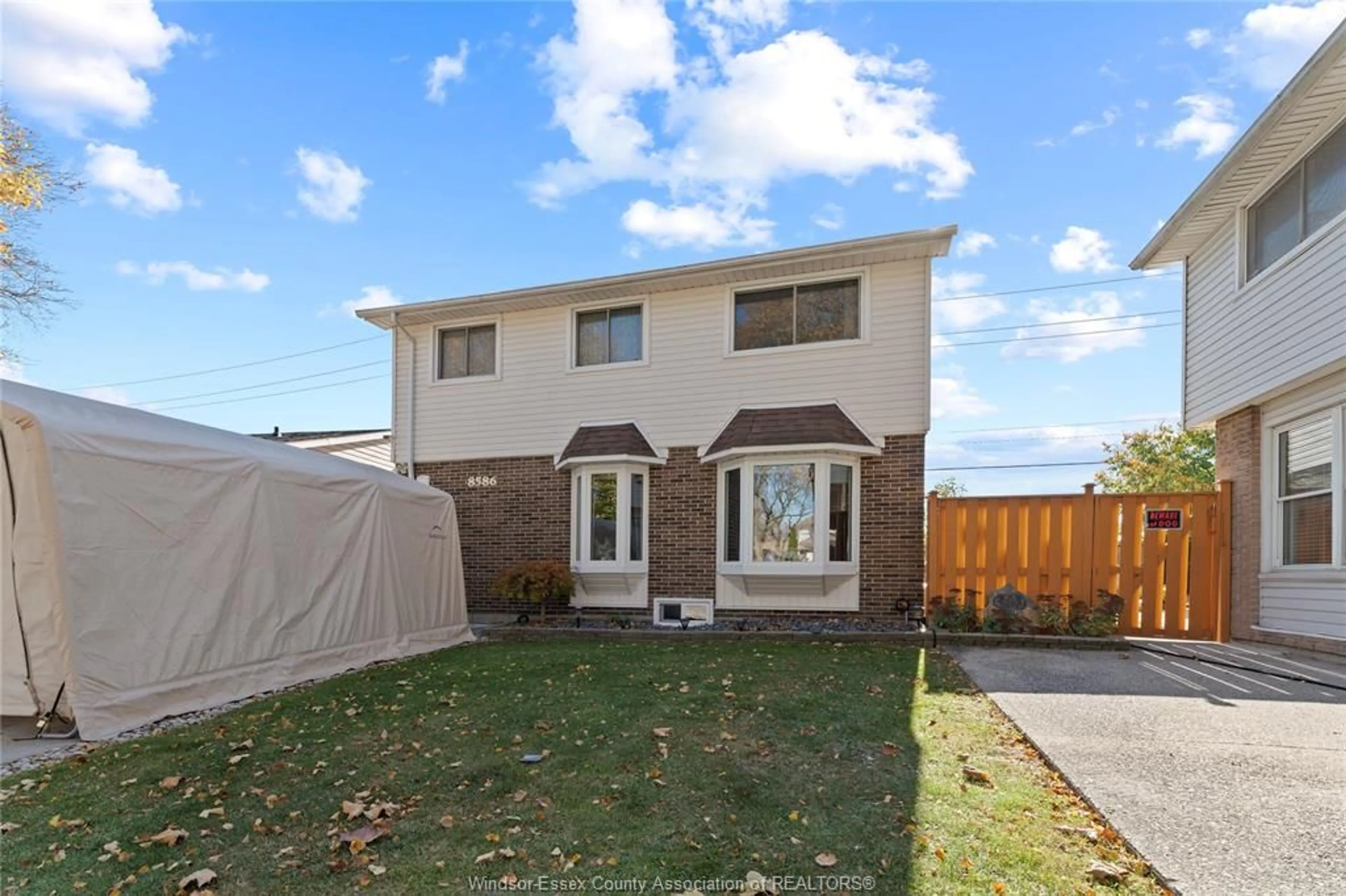 Frontside or backside of a home, the fenced backyard for 8586 DARLINGTON Cres, Windsor Ontario N8S 1N4