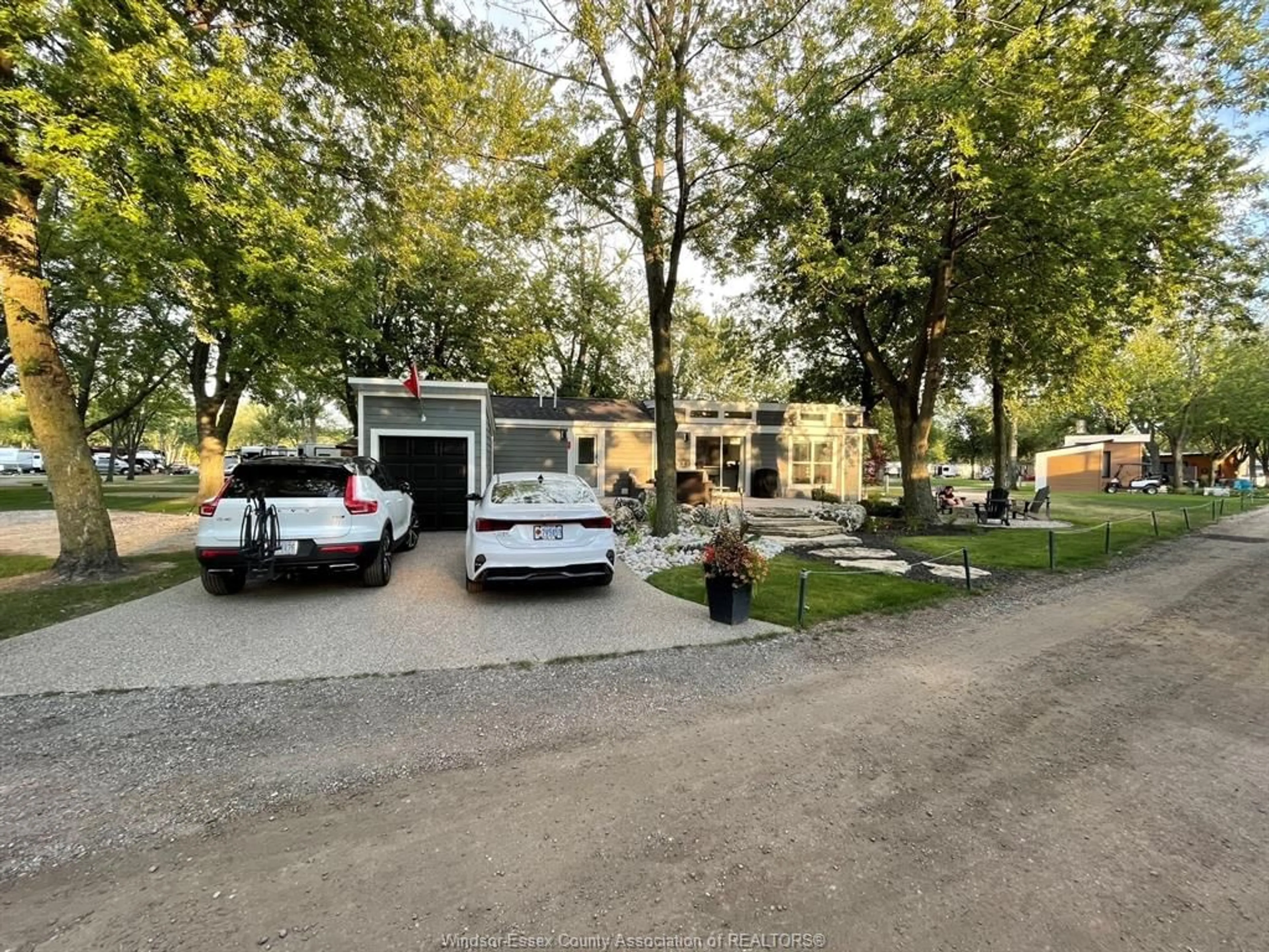 A pic from outside/outdoor area/front of a property/back of a property/a pic from drone, street for 981 COUNTY RD 2 #530, Lakeshore Ontario N0R 1A0