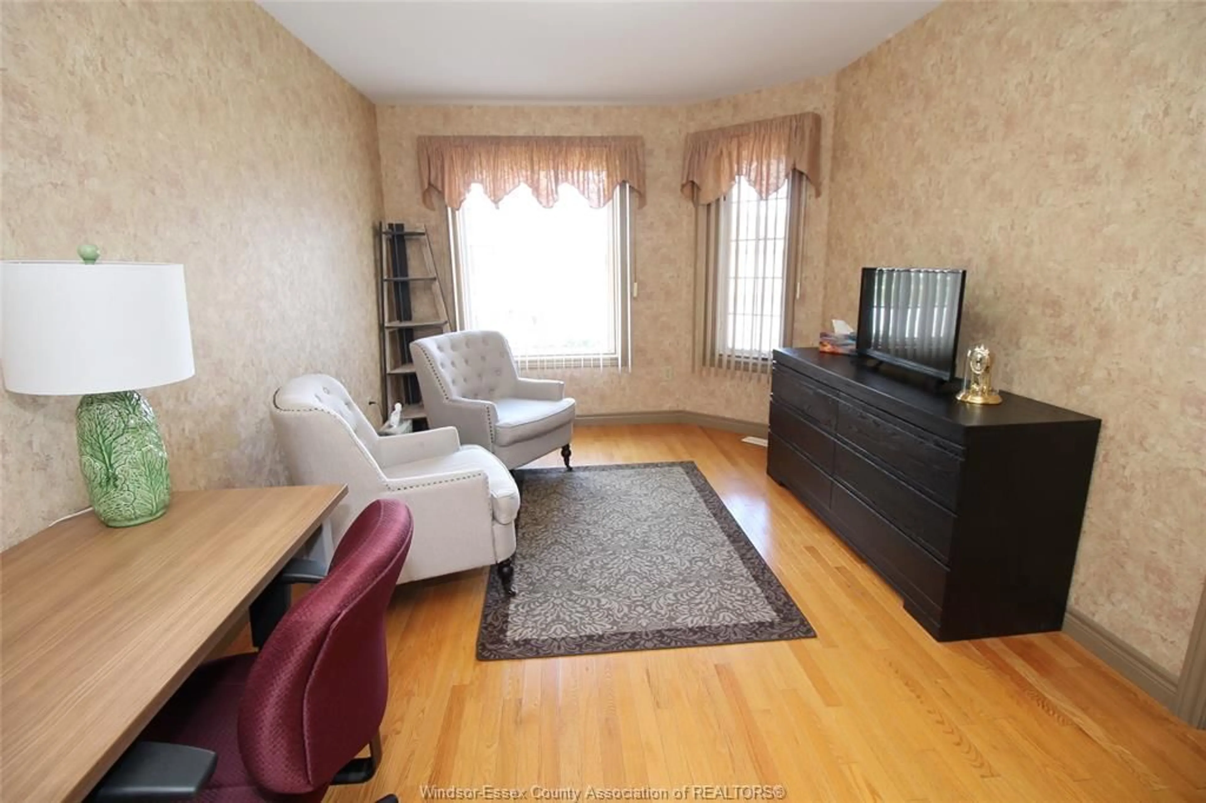 Living room with furniture, wood/laminate floor for 11037 FIRGROVE Dr, Windsor Ontario N8P 1T2