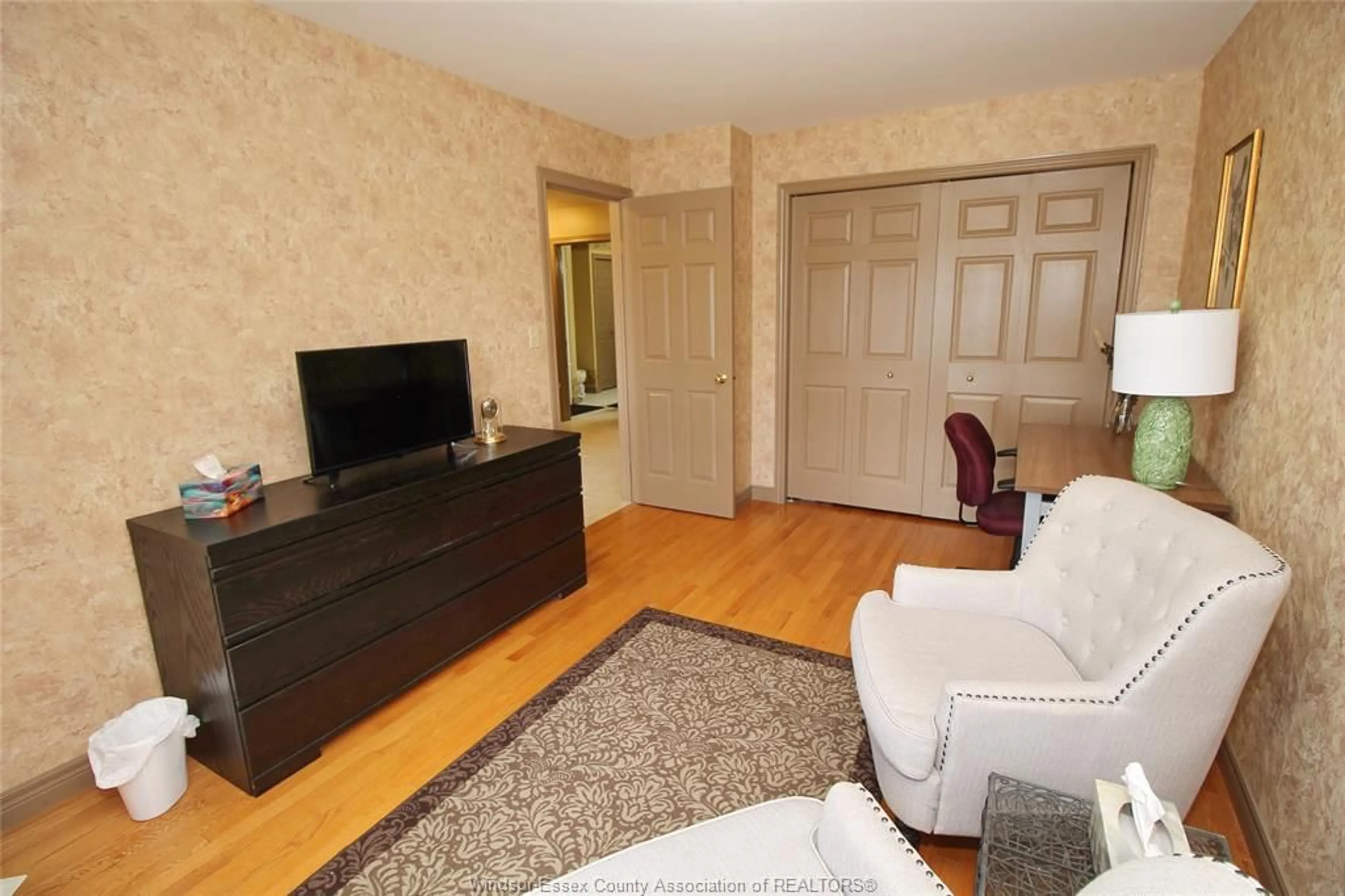 Living room with furniture, wood/laminate floor for 11037 FIRGROVE Dr, Windsor Ontario N8P 1T2