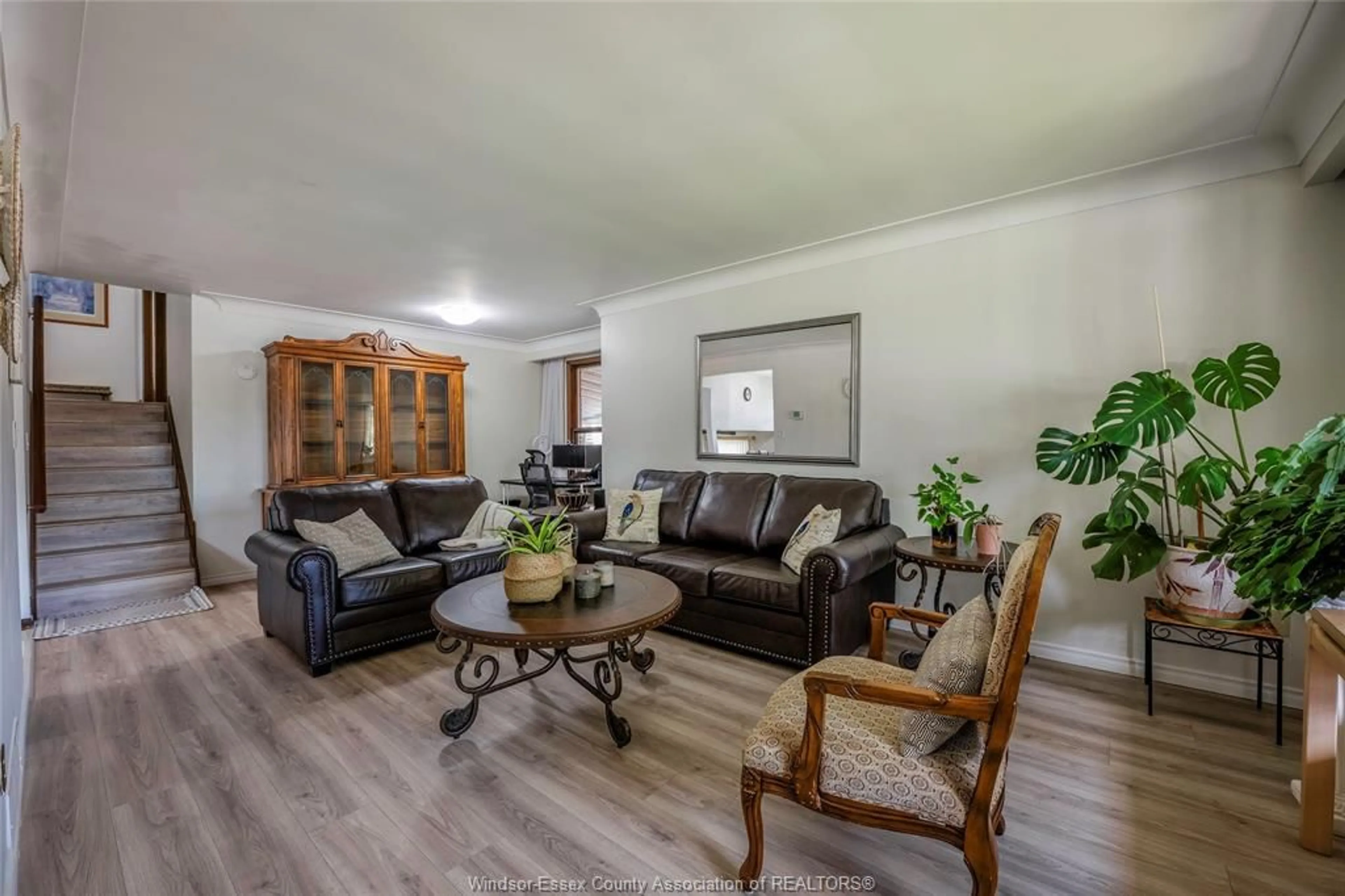 Living room with furniture, wood/laminate floor for 9610 Asgard Rd, Windsor Ontario N8R 1E2