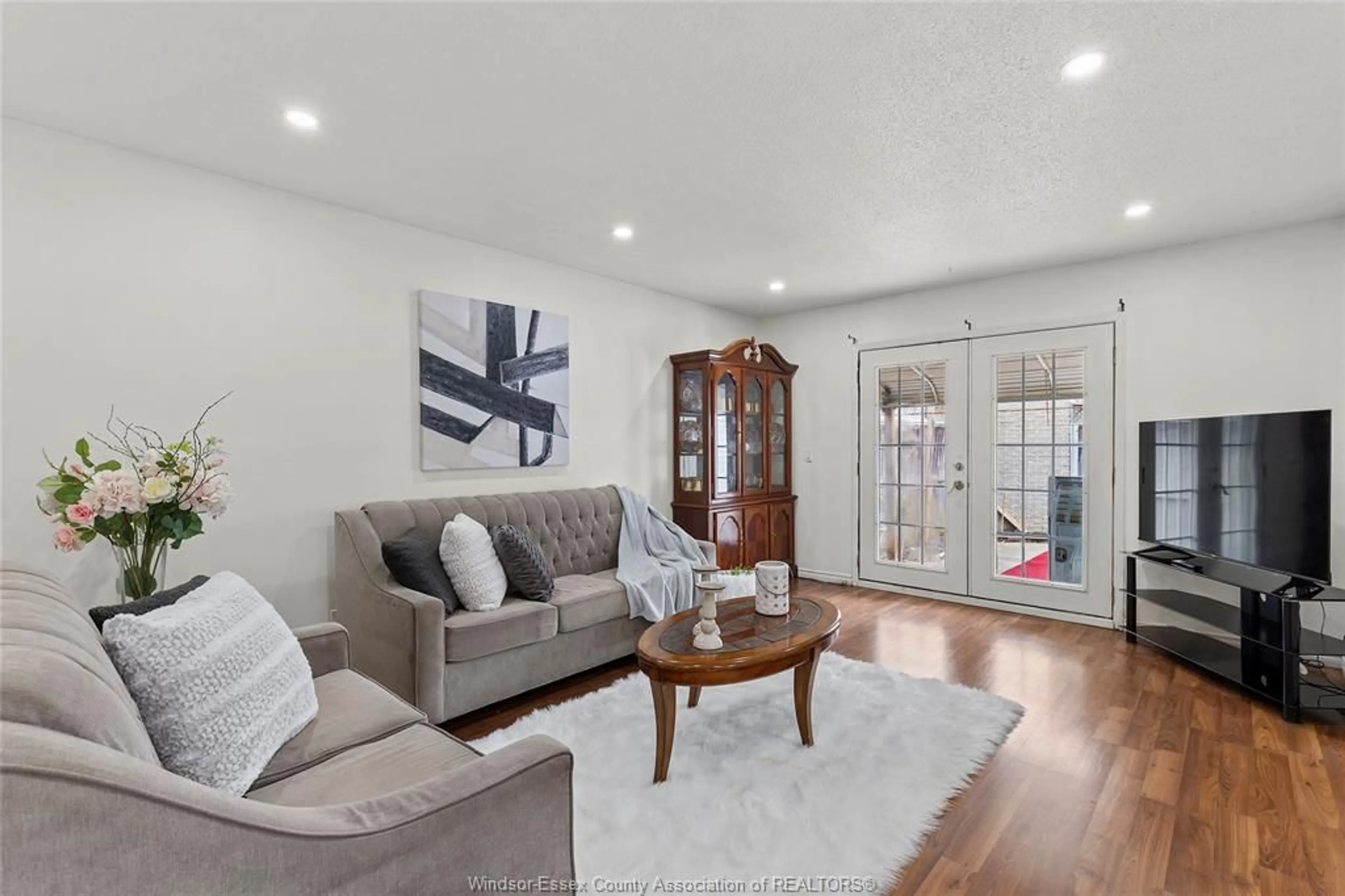 Living room with furniture, wood/laminate floor for 8671 DARLINGTON Cres, Windsor Ontario N8S 4M2