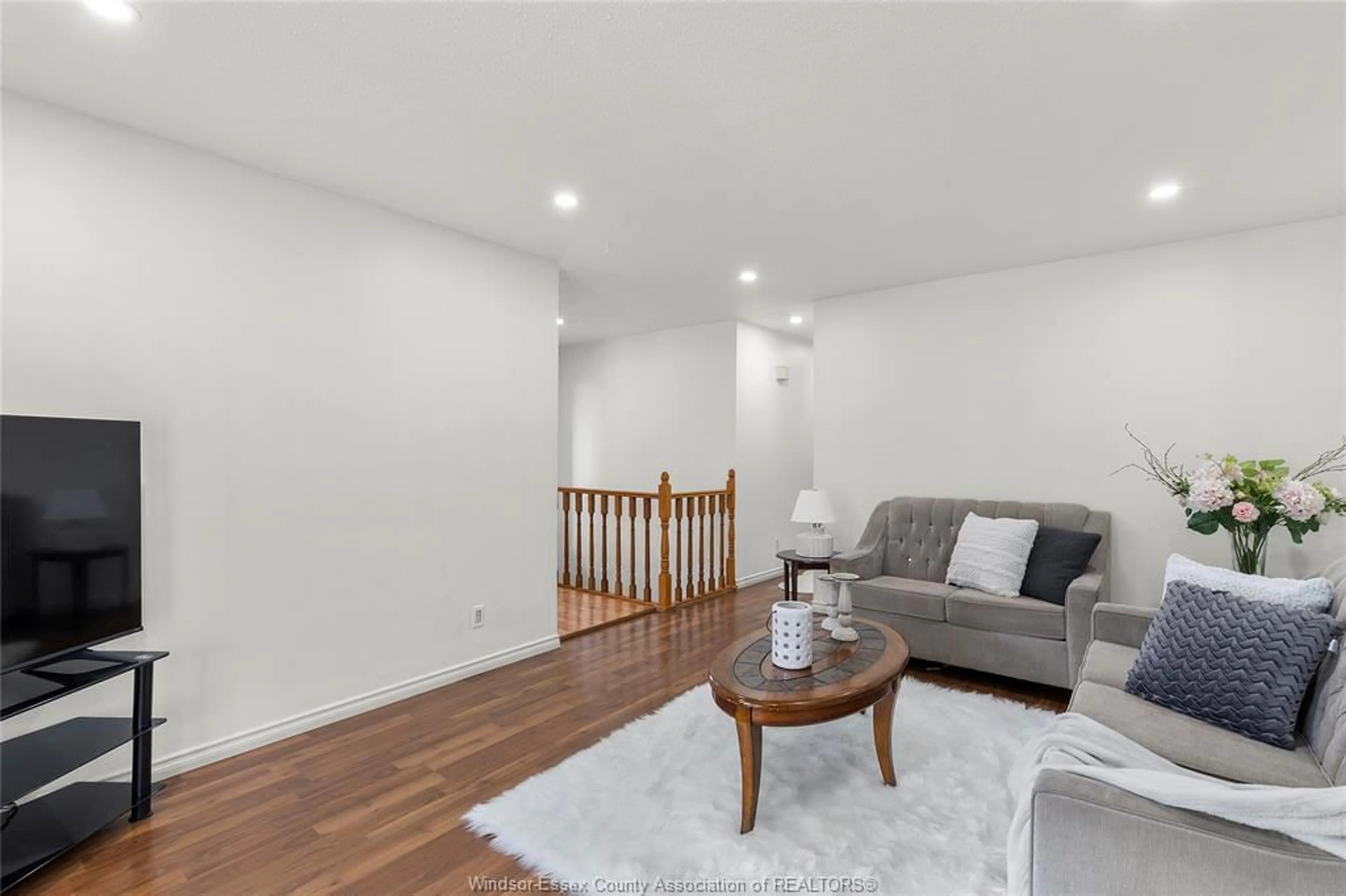 Living room with furniture, wood/laminate floor for 8671 DARLINGTON Cres, Windsor Ontario N8S 4M2
