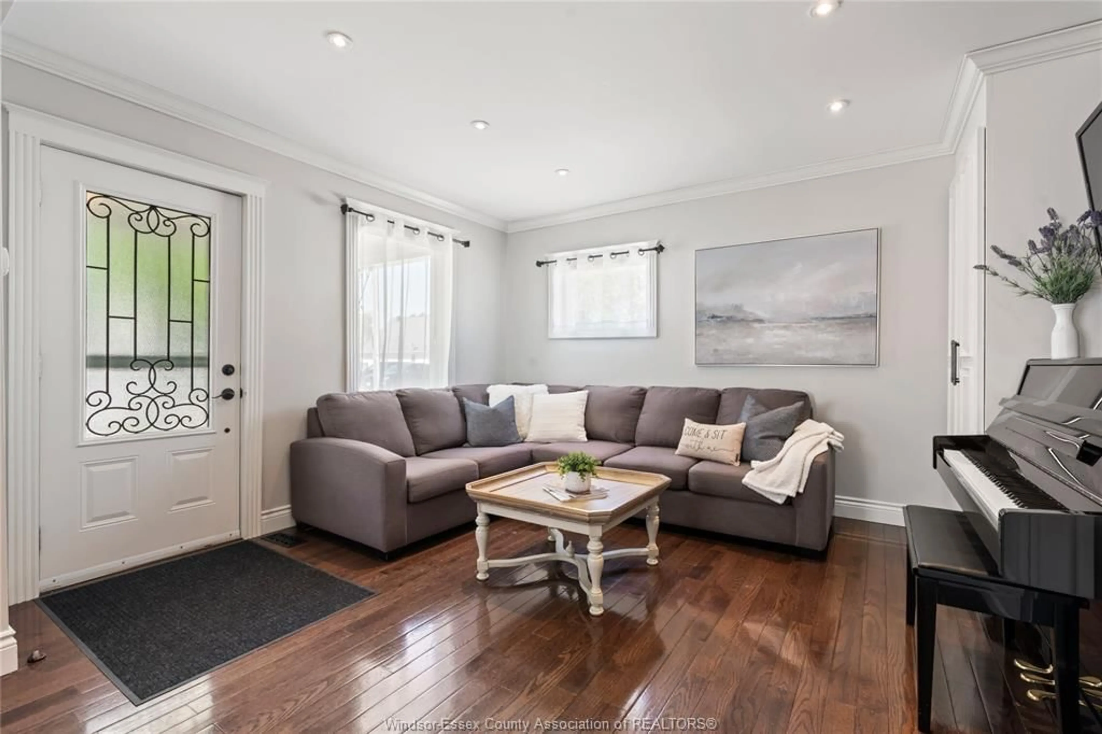 Living room with furniture, wood/laminate floor for 103 ST. JAMES, Essex Ontario N8M 1E5