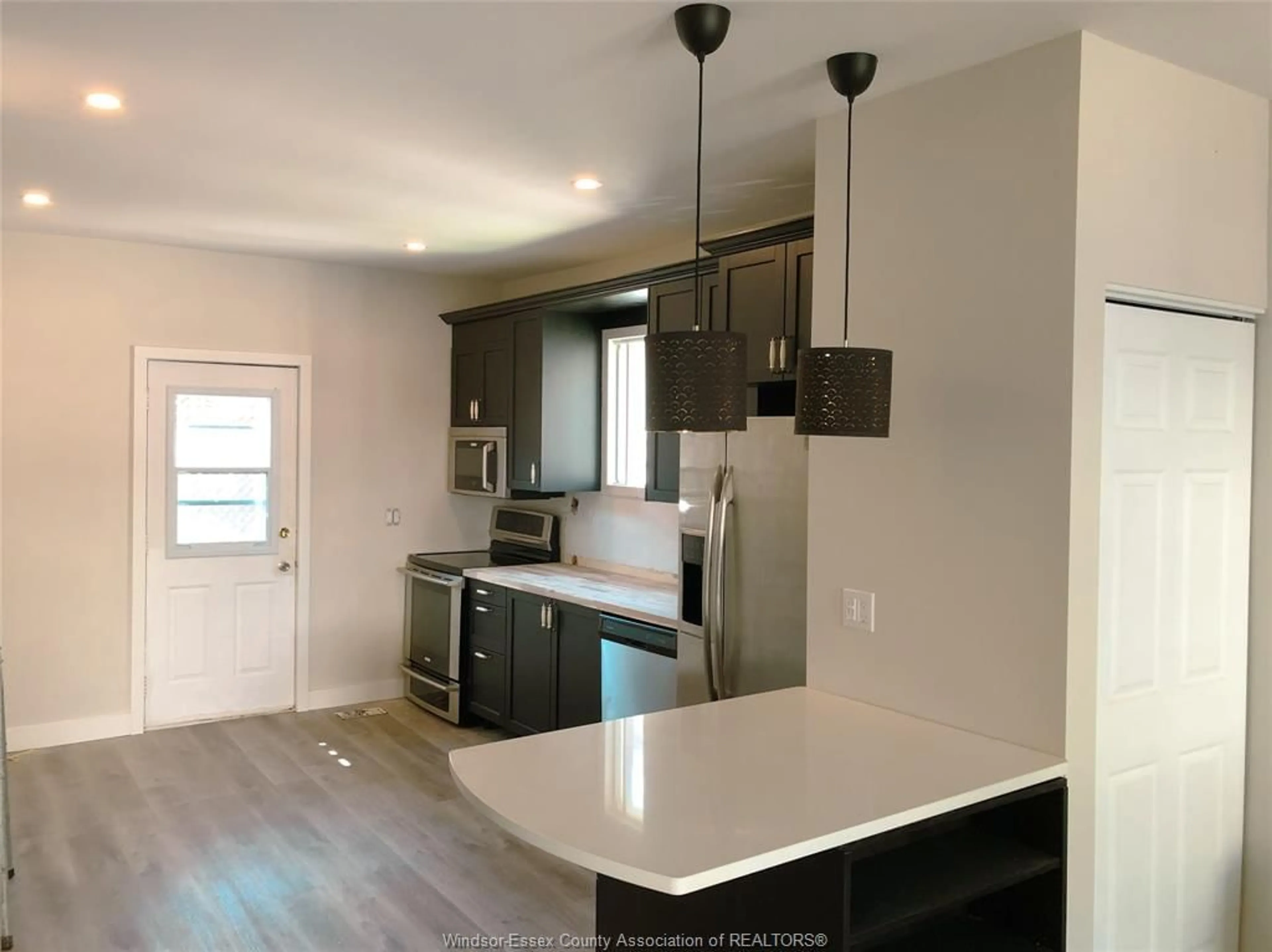 Open concept kitchen, wood/laminate floor for 439 Chilver Rd, Windsor Ontario N8Y 2J8