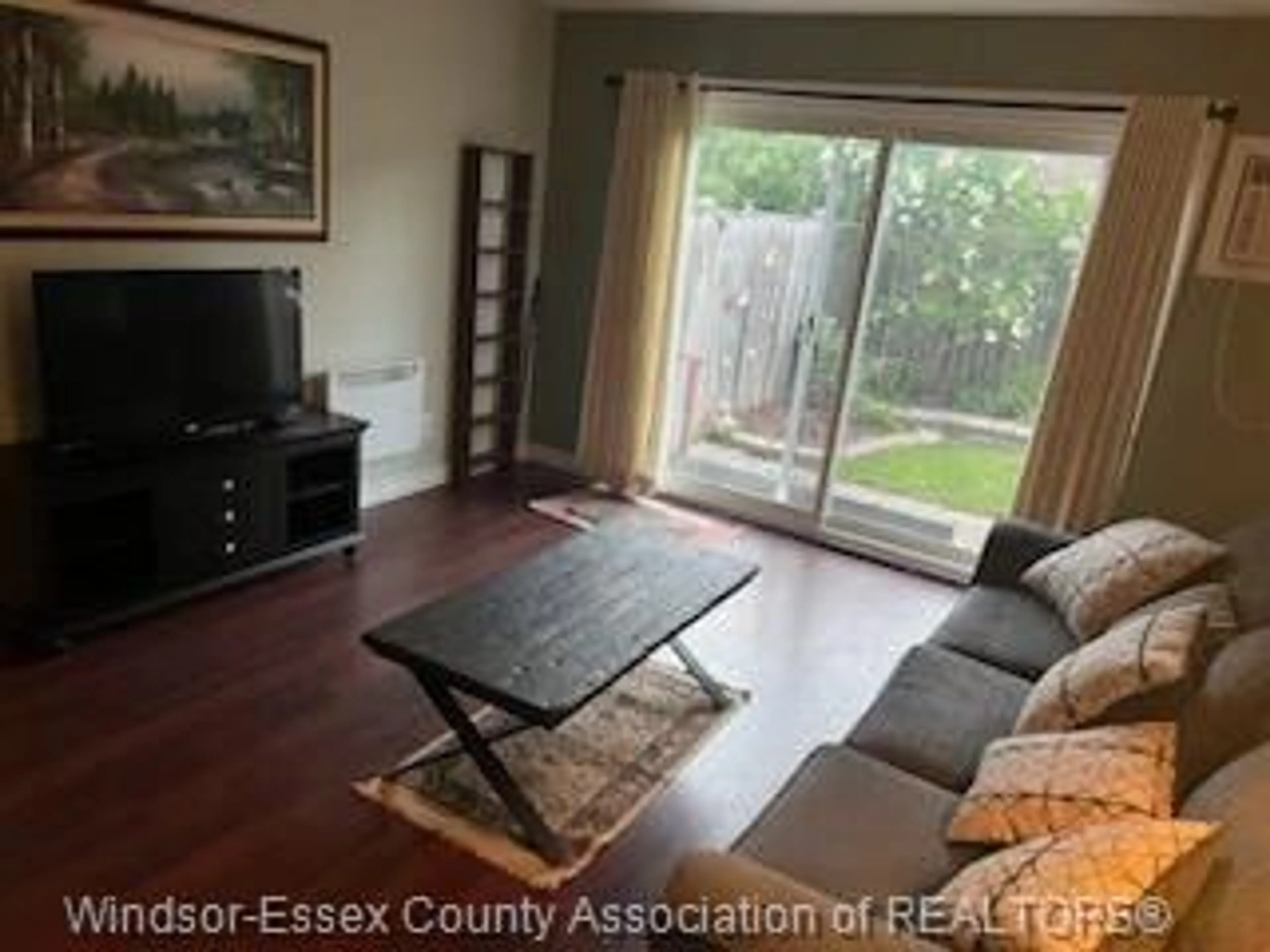 Living room with furniture, wood/laminate floor for 8270 Gateside Place, Windsor Ontario N8S 4N6