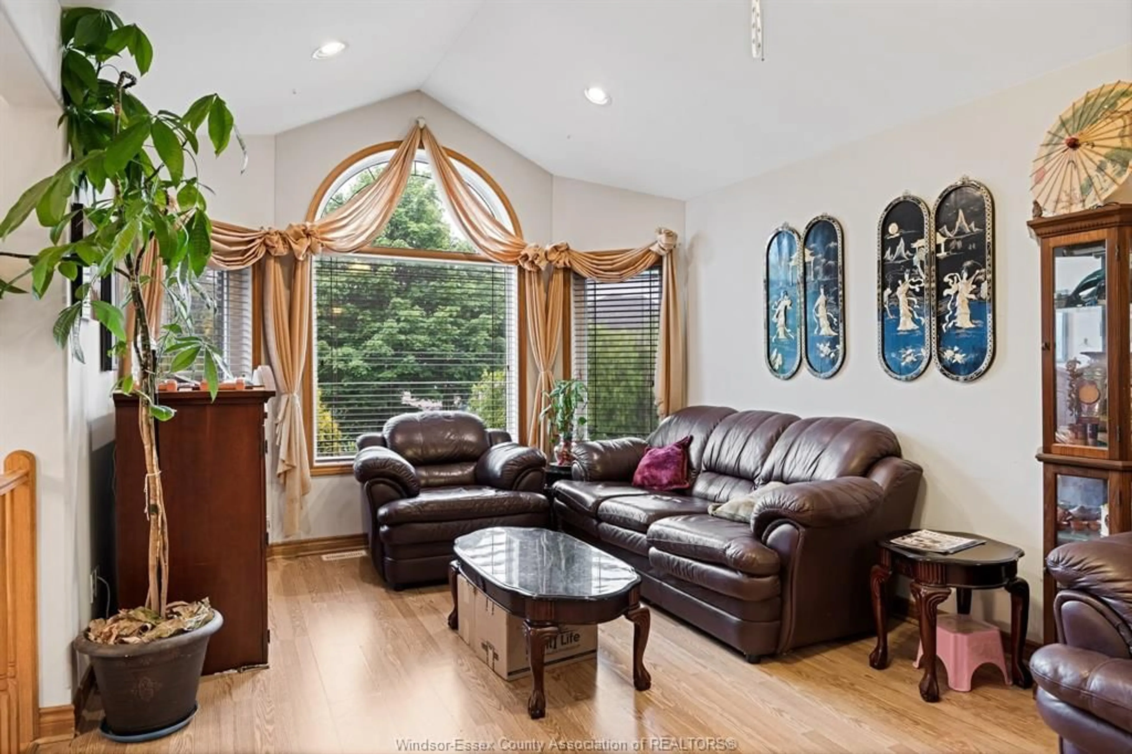 Living room with furniture, wood/laminate floor for 1652 Stoneybrook Cres, Windsor Ontario N9G 2S9