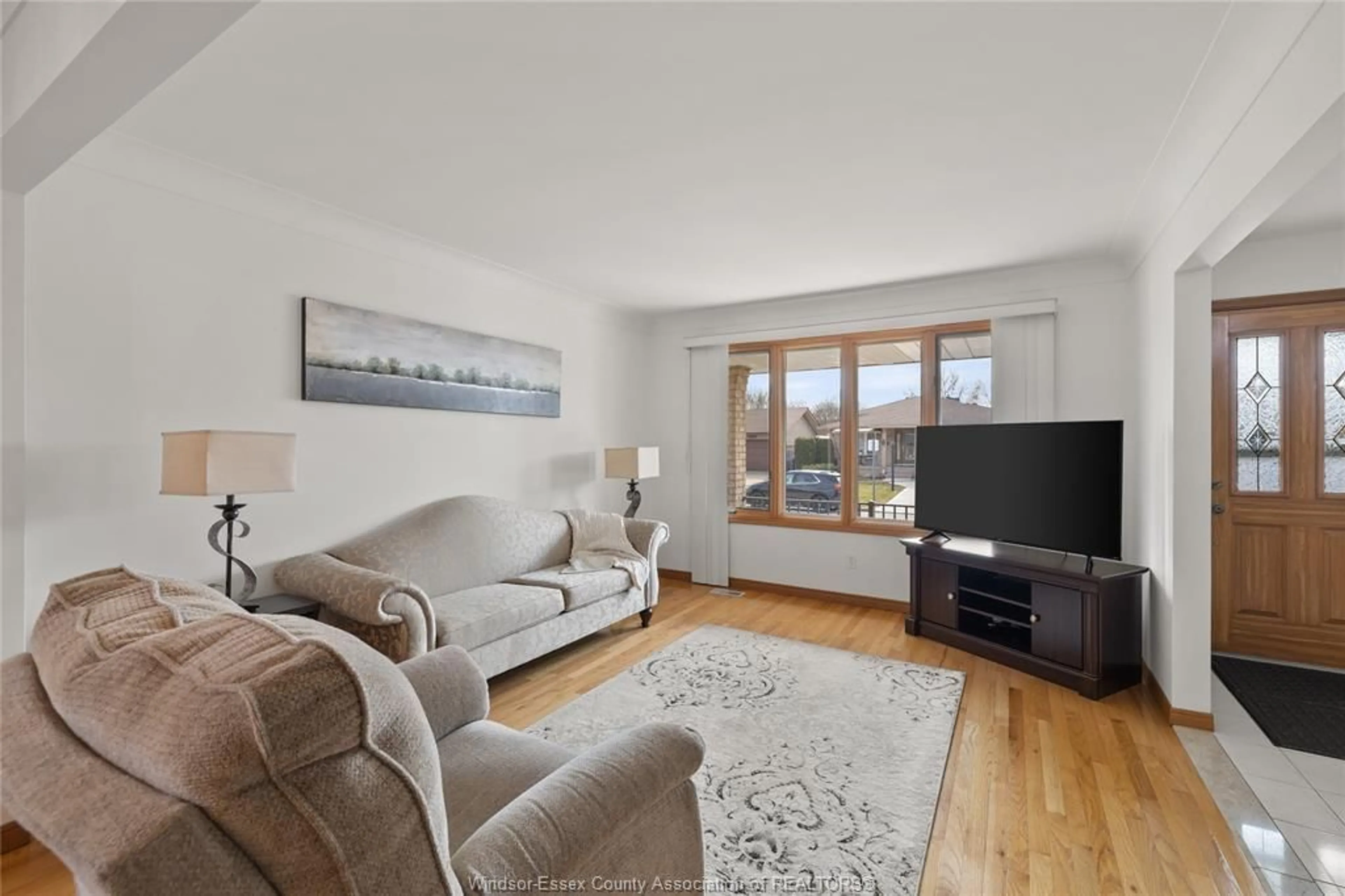 Living room with furniture, wood/laminate floor for 8358 KINGSTON Cres, Windsor Ontario N8S 4R8