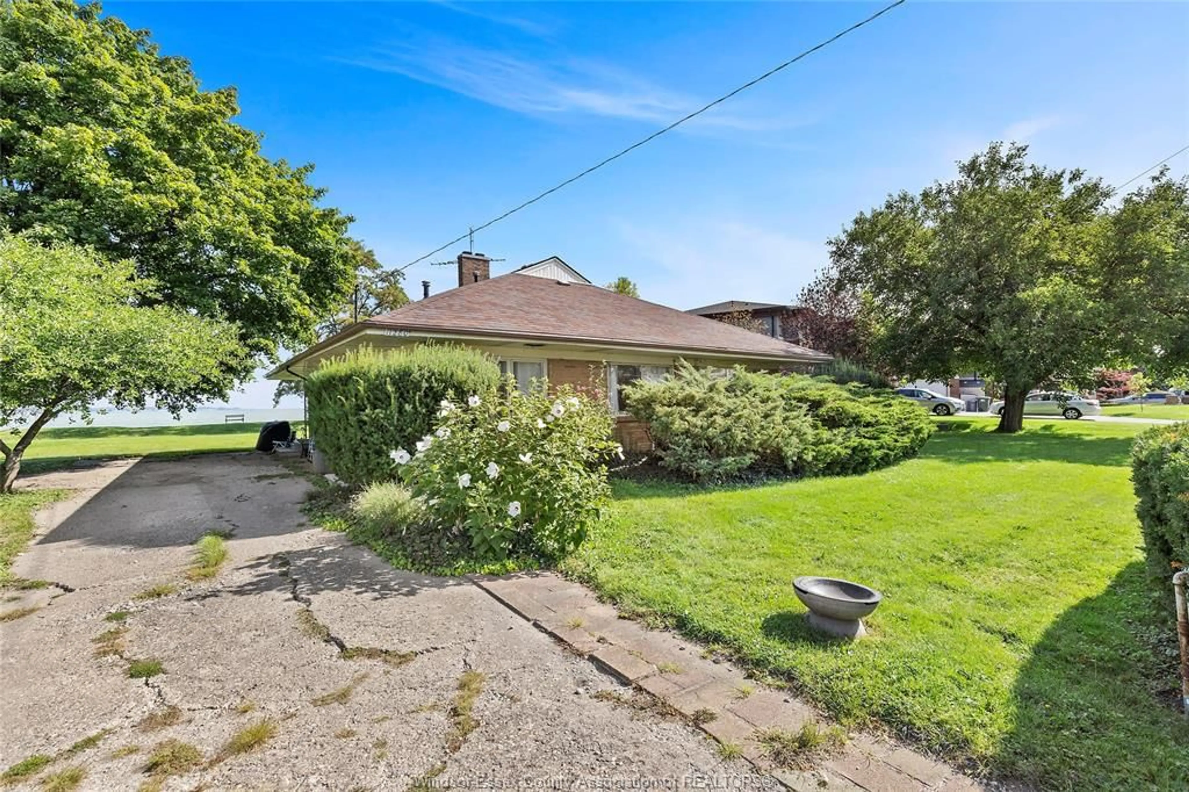 A pic from outside/outdoor area/front of a property/back of a property/a pic from drone, street for 11280 RIVERSIDE Dr, Windsor Ontario N8P 1A4