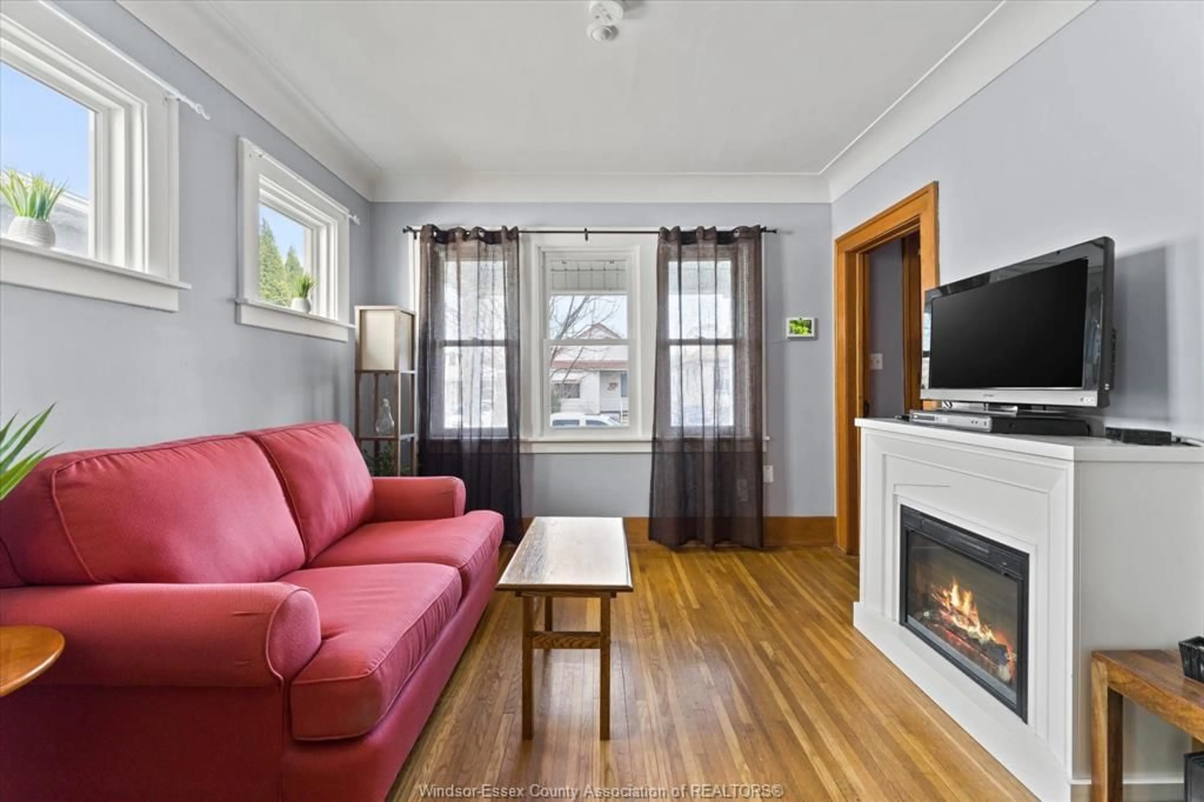 Living room with furniture, wood/laminate floor for 1673 CADILLAC, Windsor Ontario N8Y 2V6
