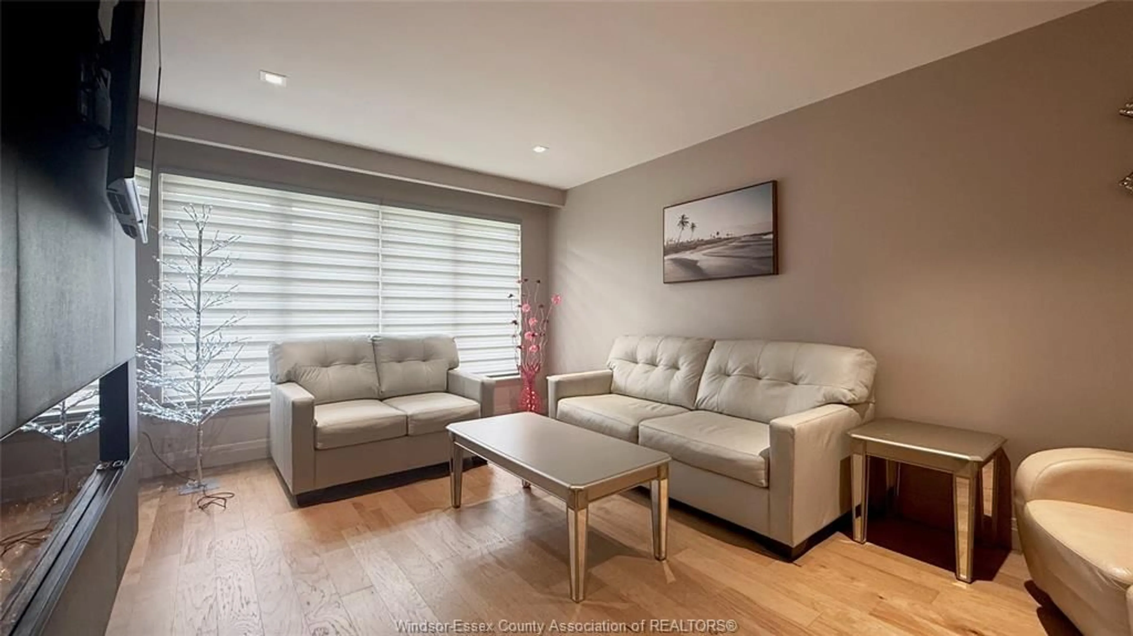 Living room with furniture, wood/laminate floor for 9793 LYNNGROVE, Windsor Ontario N8R 1B8