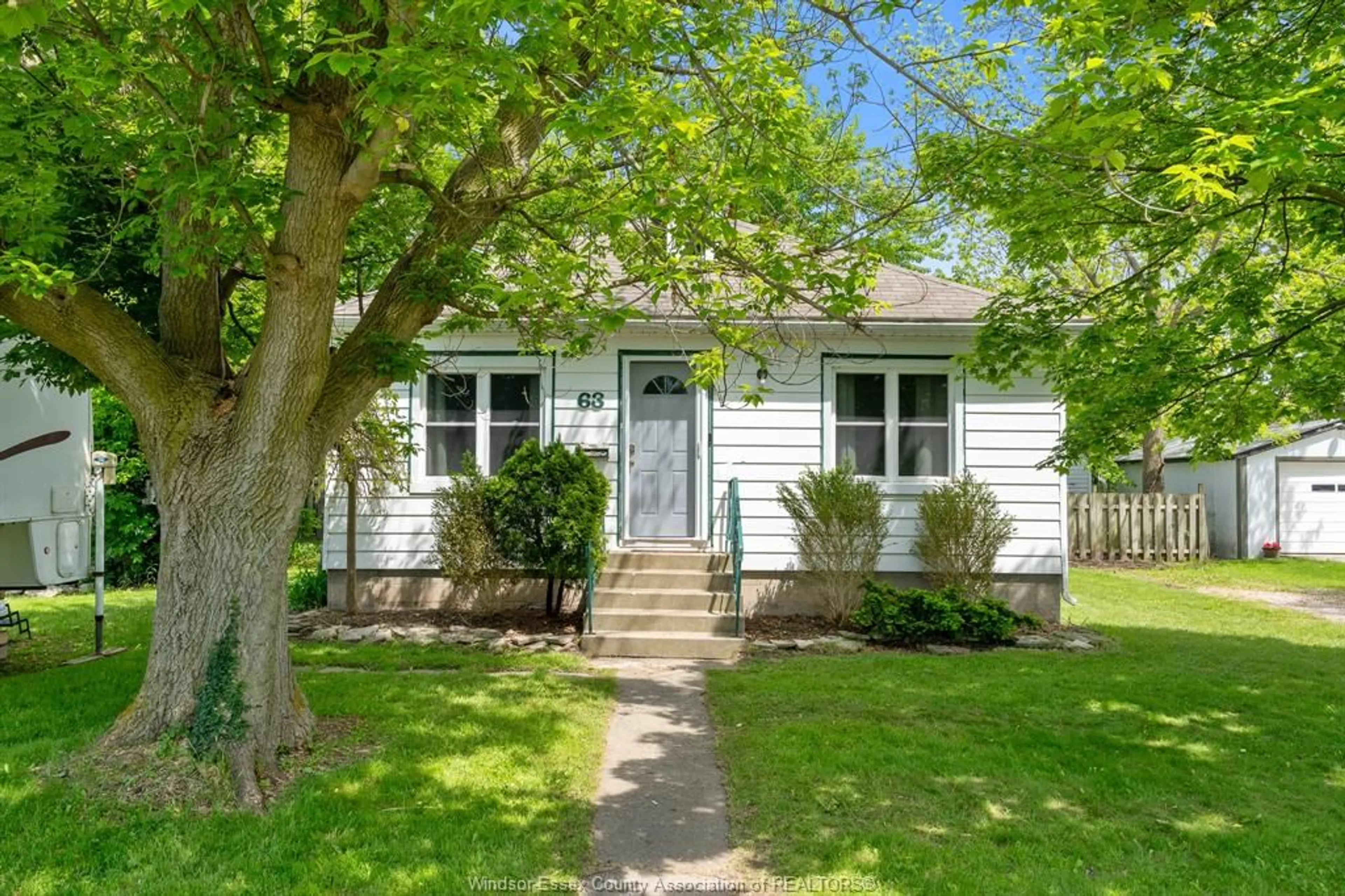 Home with vinyl exterior material, street for 63 Baird Ave, Wheatley Ontario N0P 2P0