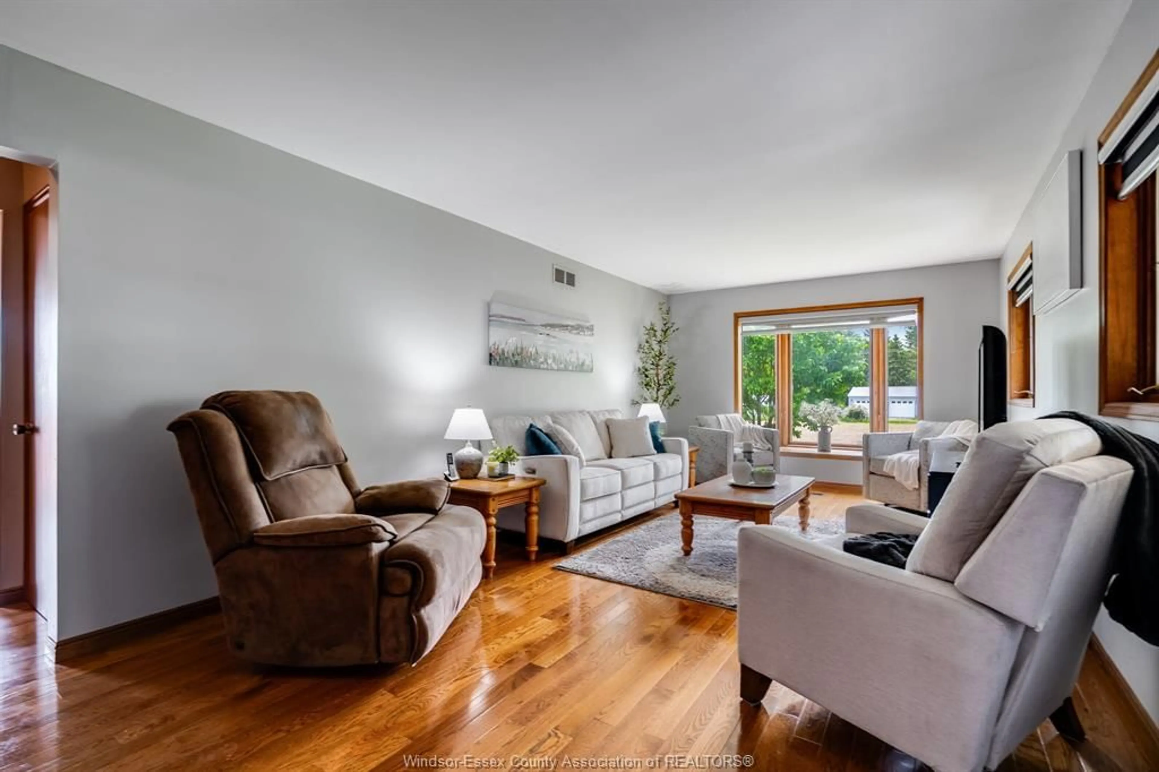 Living room with furniture, wood/laminate floor for 236 County Road 34, Cottam Ontario N8M 2X5