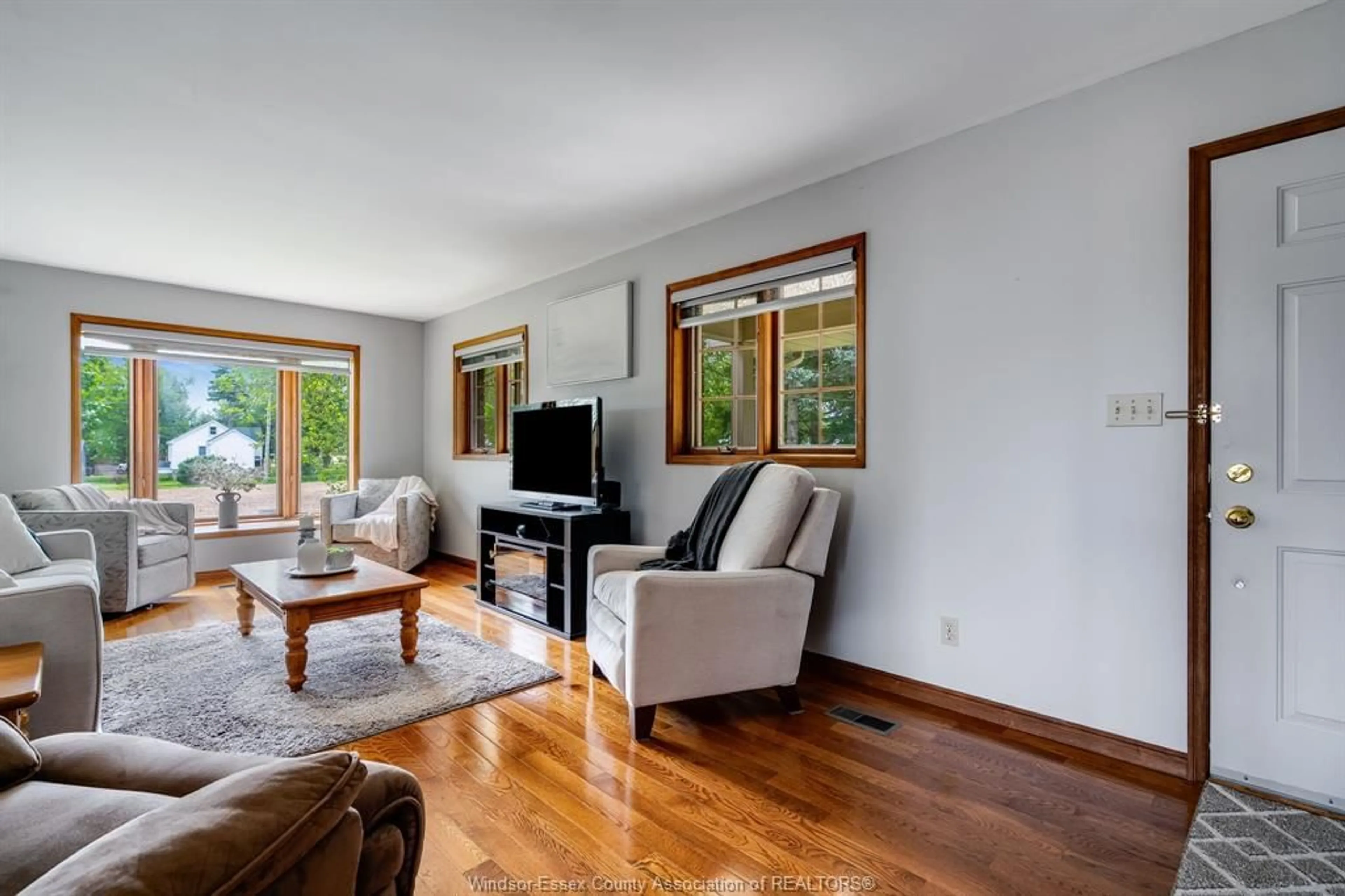 Living room with furniture, wood/laminate floor for 236 County Road 34, Cottam Ontario N8M 2X5