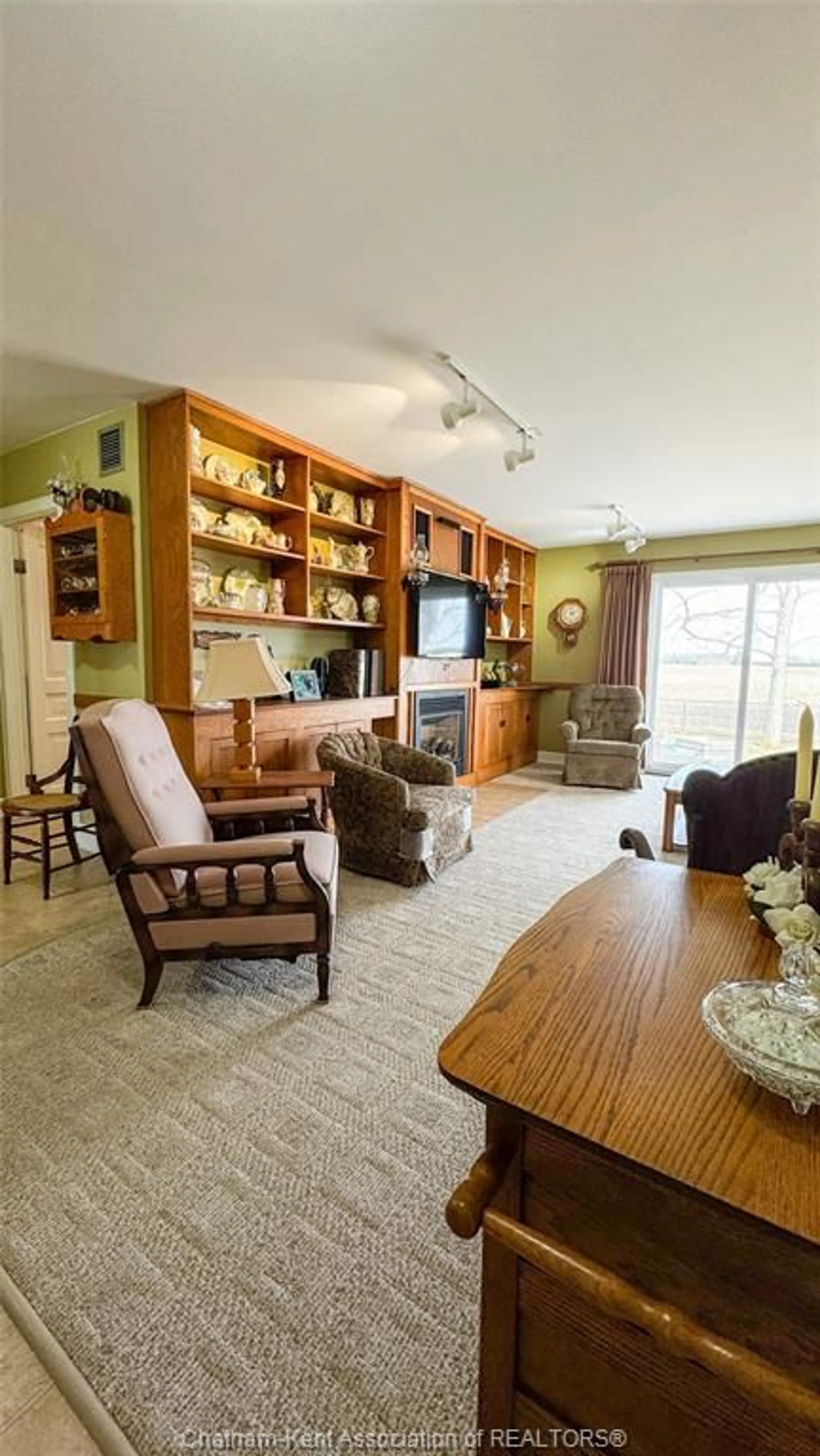Living room with furniture, wood/laminate floor for 21983 Communication Rd, Chatham-Kent Ontario N7M 5J3
